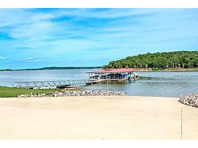 Dock area with a boat ramp and a water view