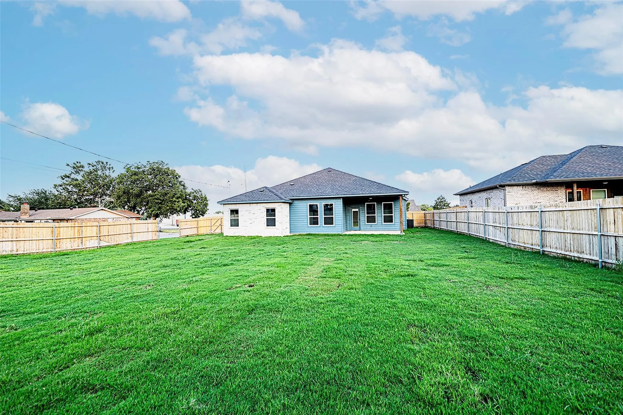 Rear view of house with a yard