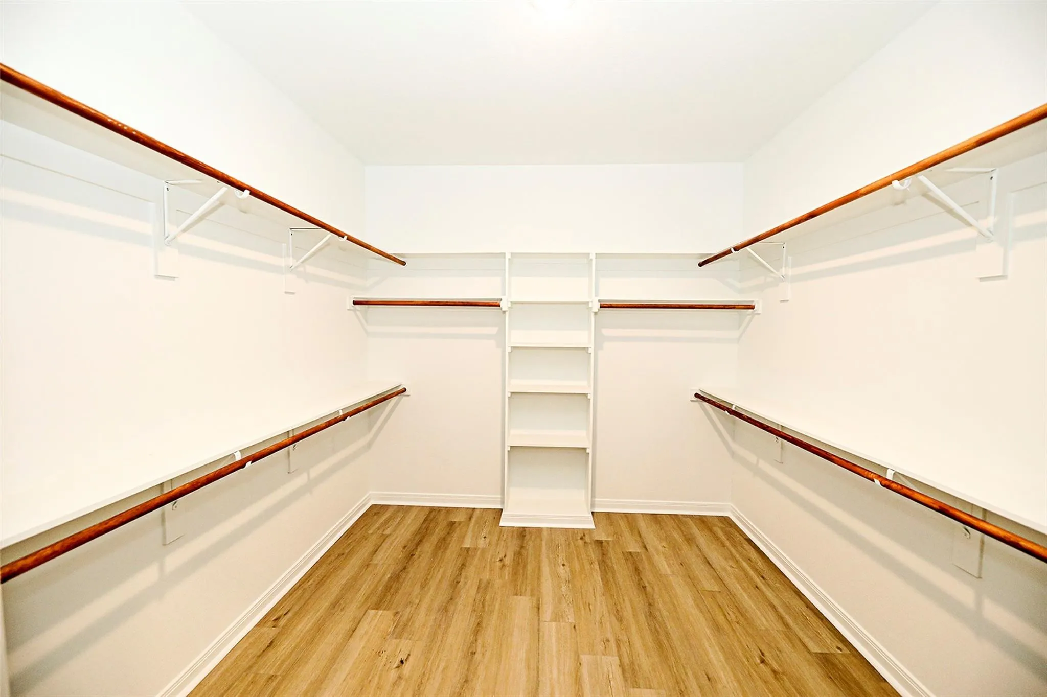 Spacious closet with light wood-type flooring