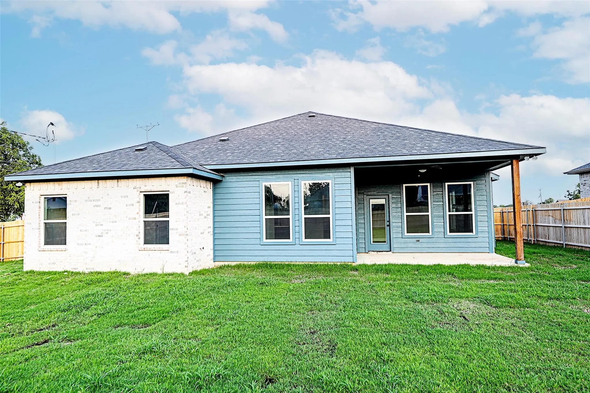 Back of property featuring a patio and a yard