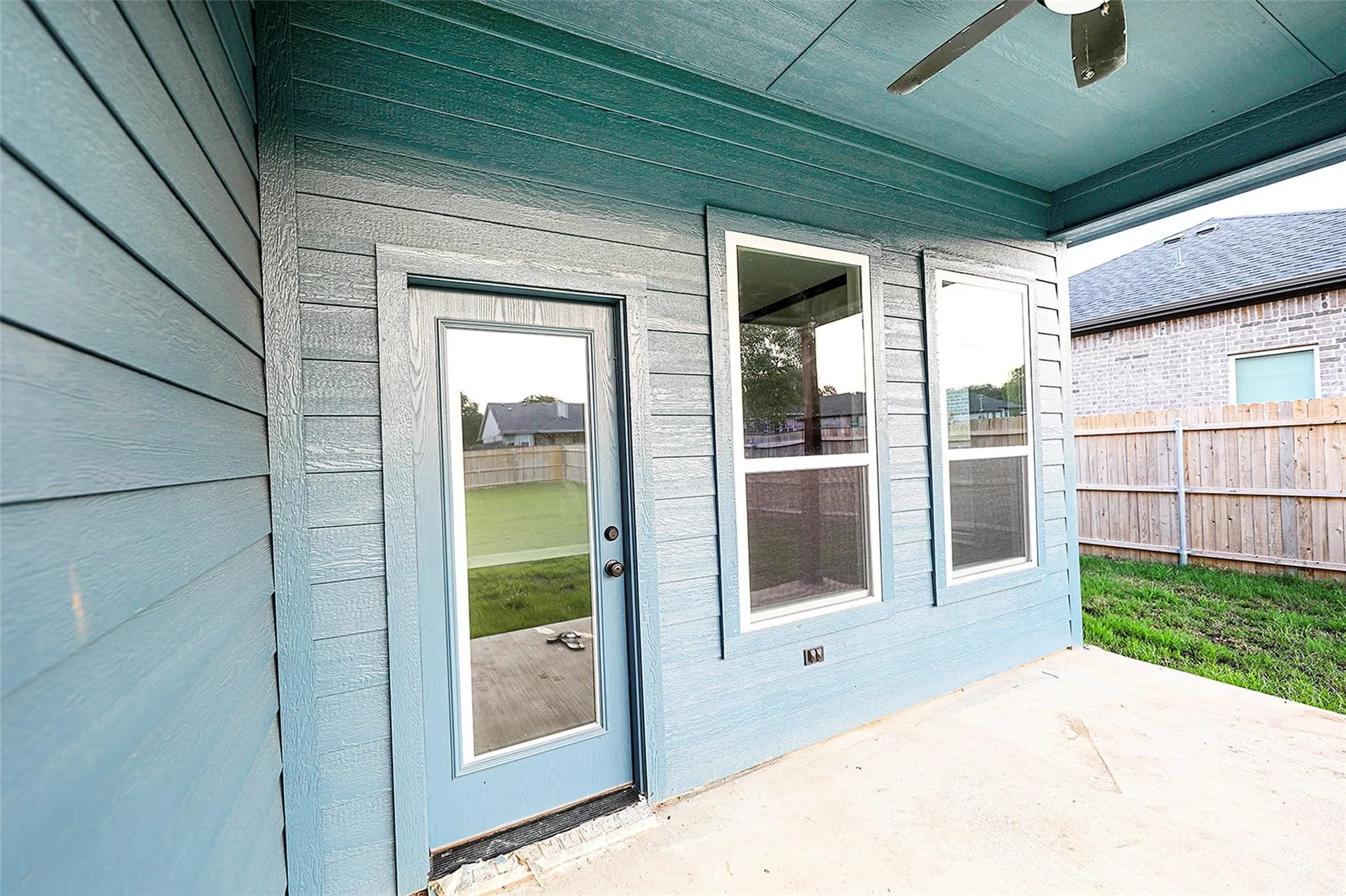 Property entrance with a patio area and ceiling fan