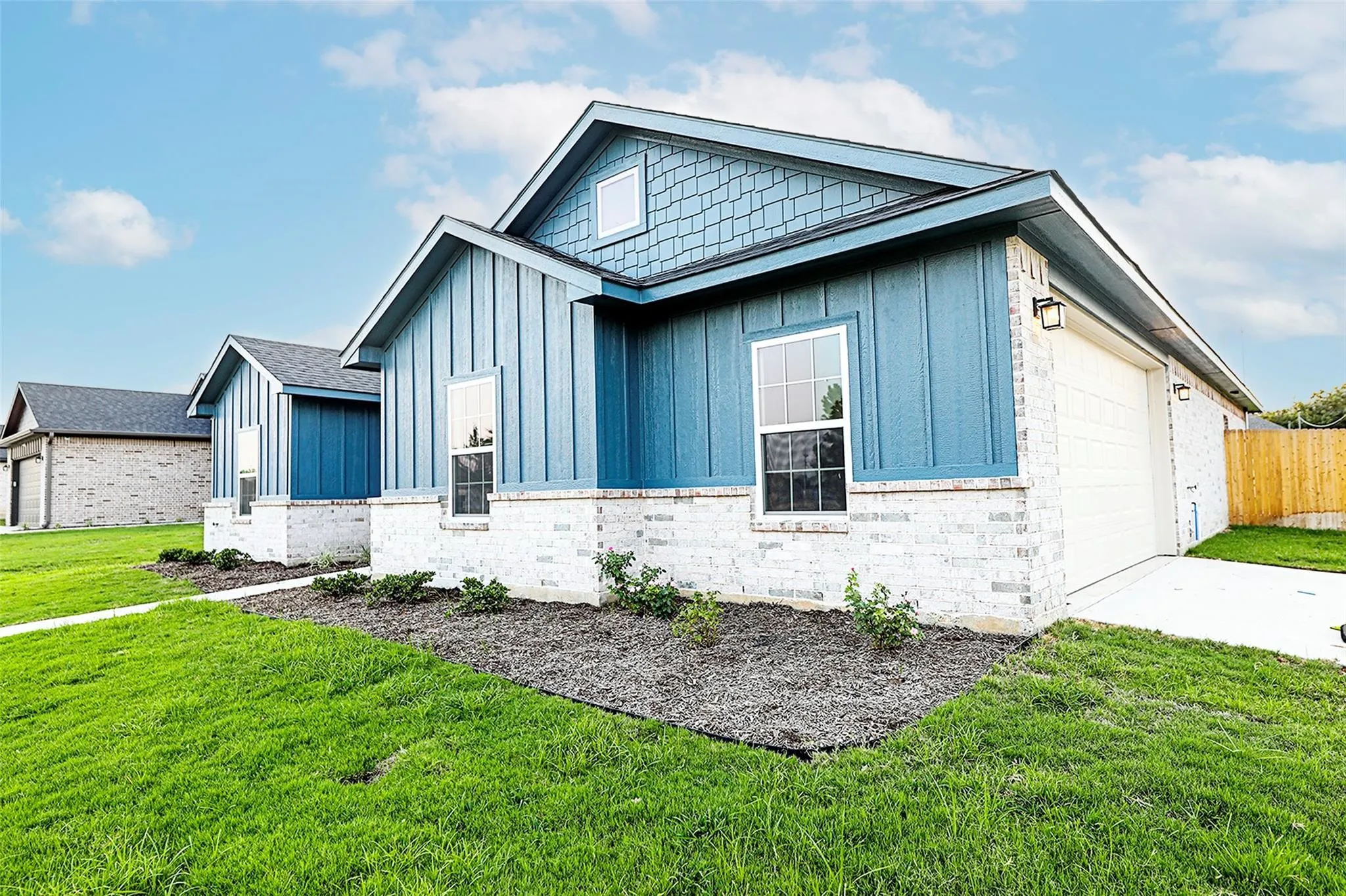 View of front of house with a front lawn and a garage