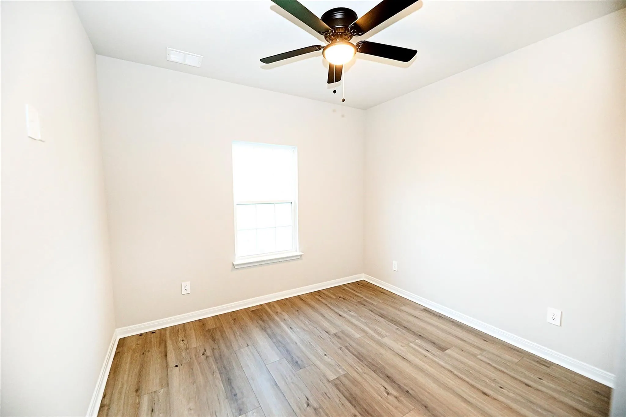 Unfurnished room featuring ceiling fan and light hardwood / wood-style floors