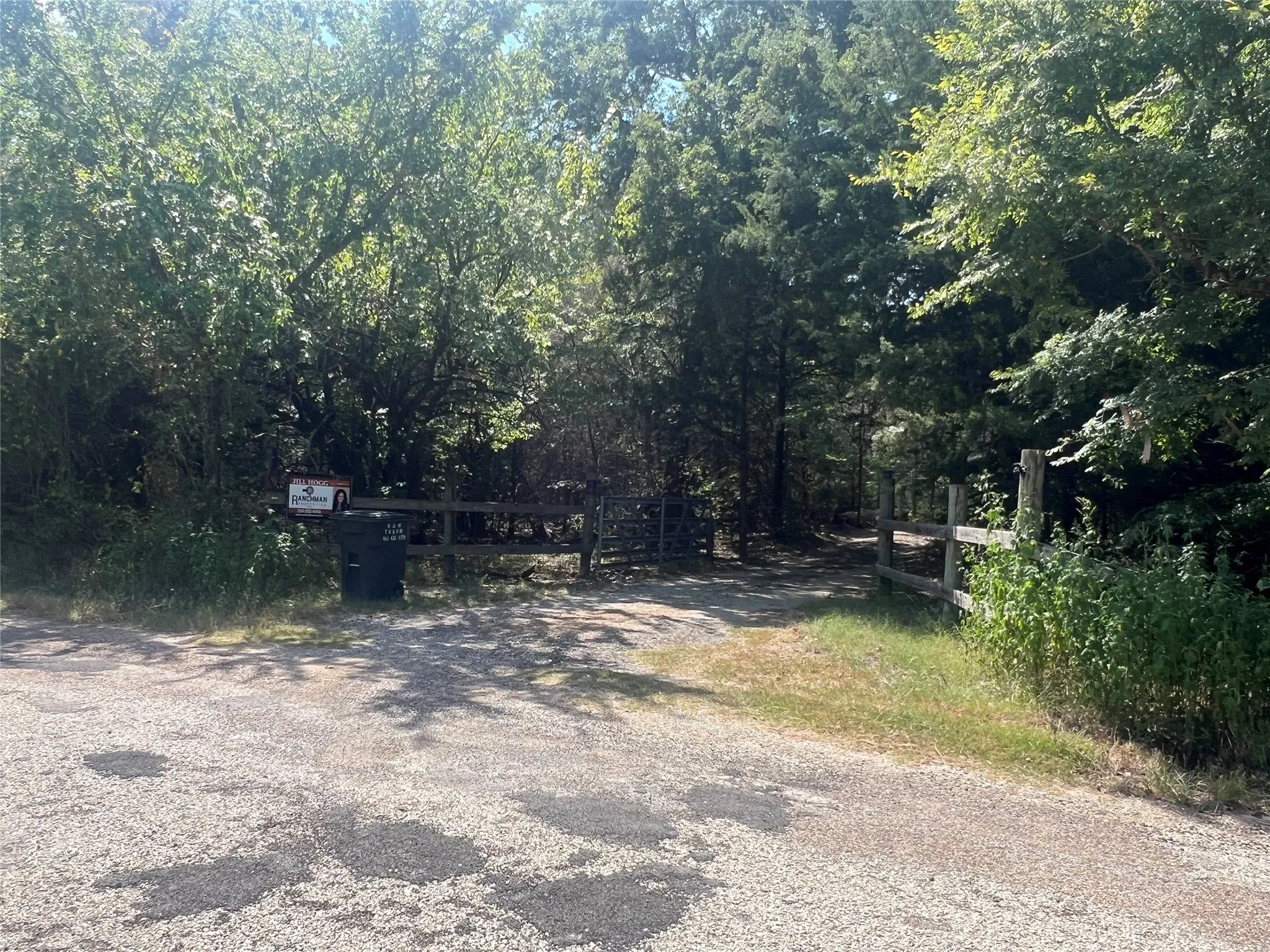 View of asphalt road featuring a view of trees