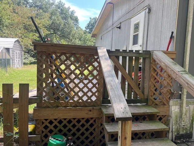 Wooden deck featuring an outbuilding