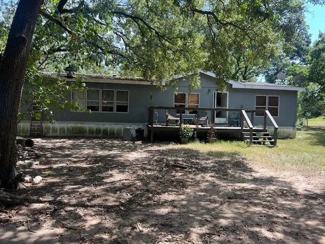 Rear view of house with a wooden deck