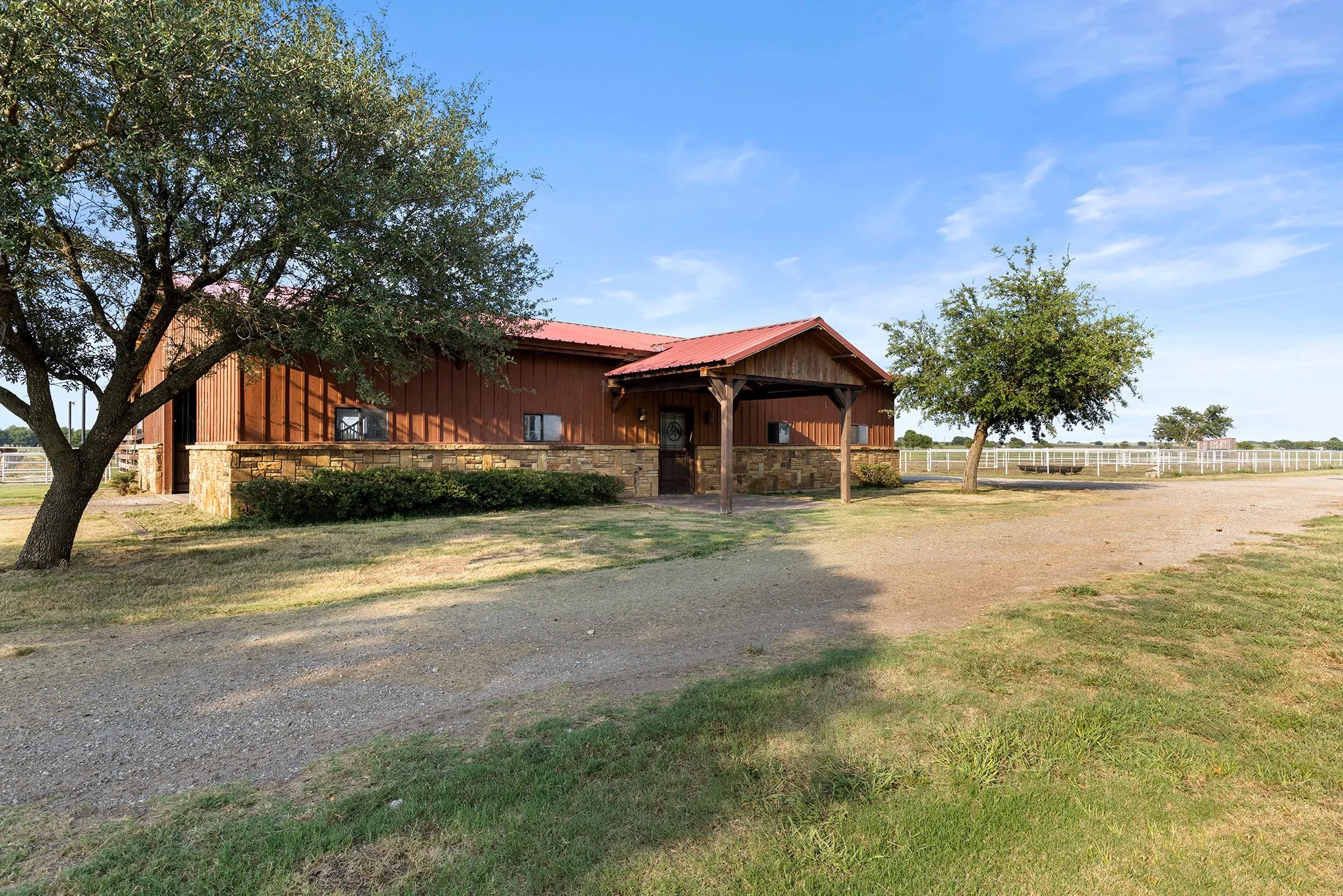Rustic home with stone siding, board and batten siding, and a metal roof