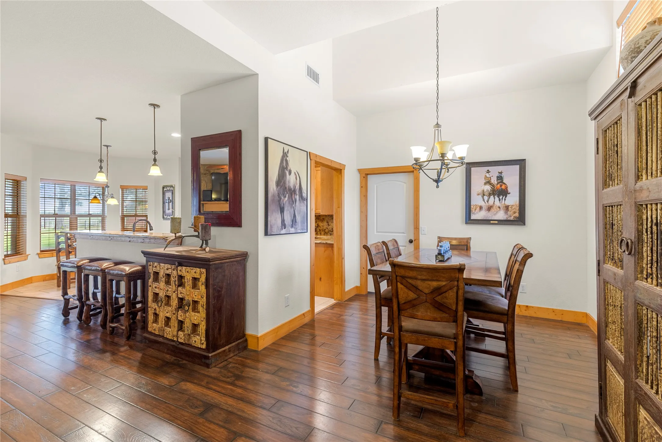 Dining room with wood-type flooring and a chandelier