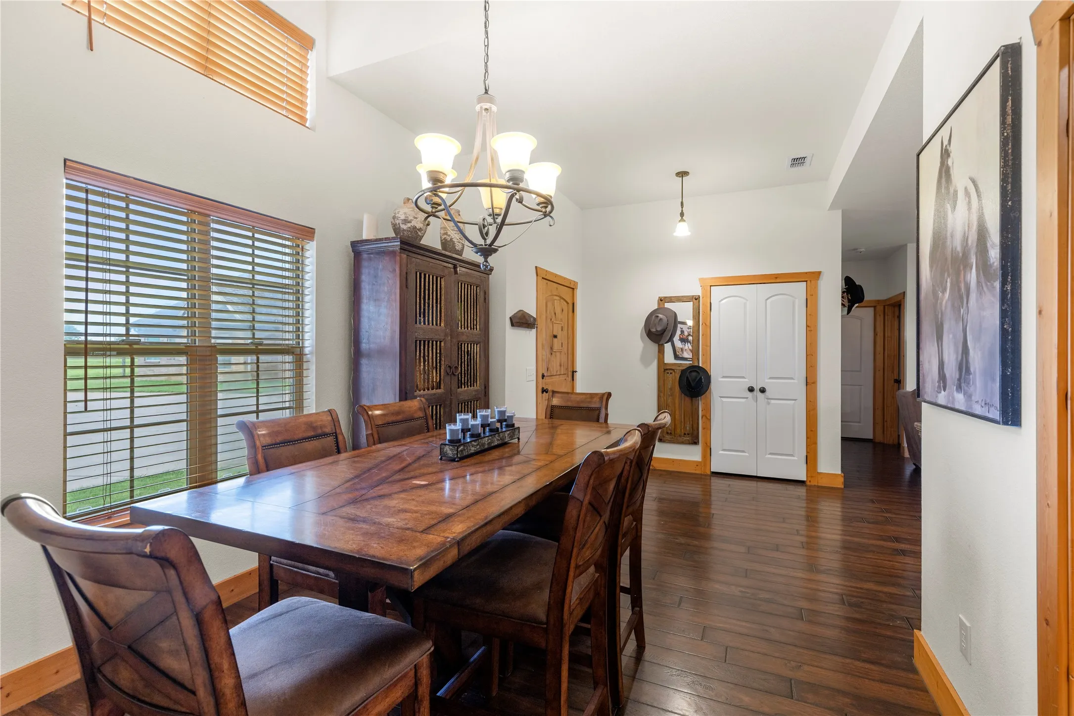 Dining area featuring dark wood-type flooring and a chandelier