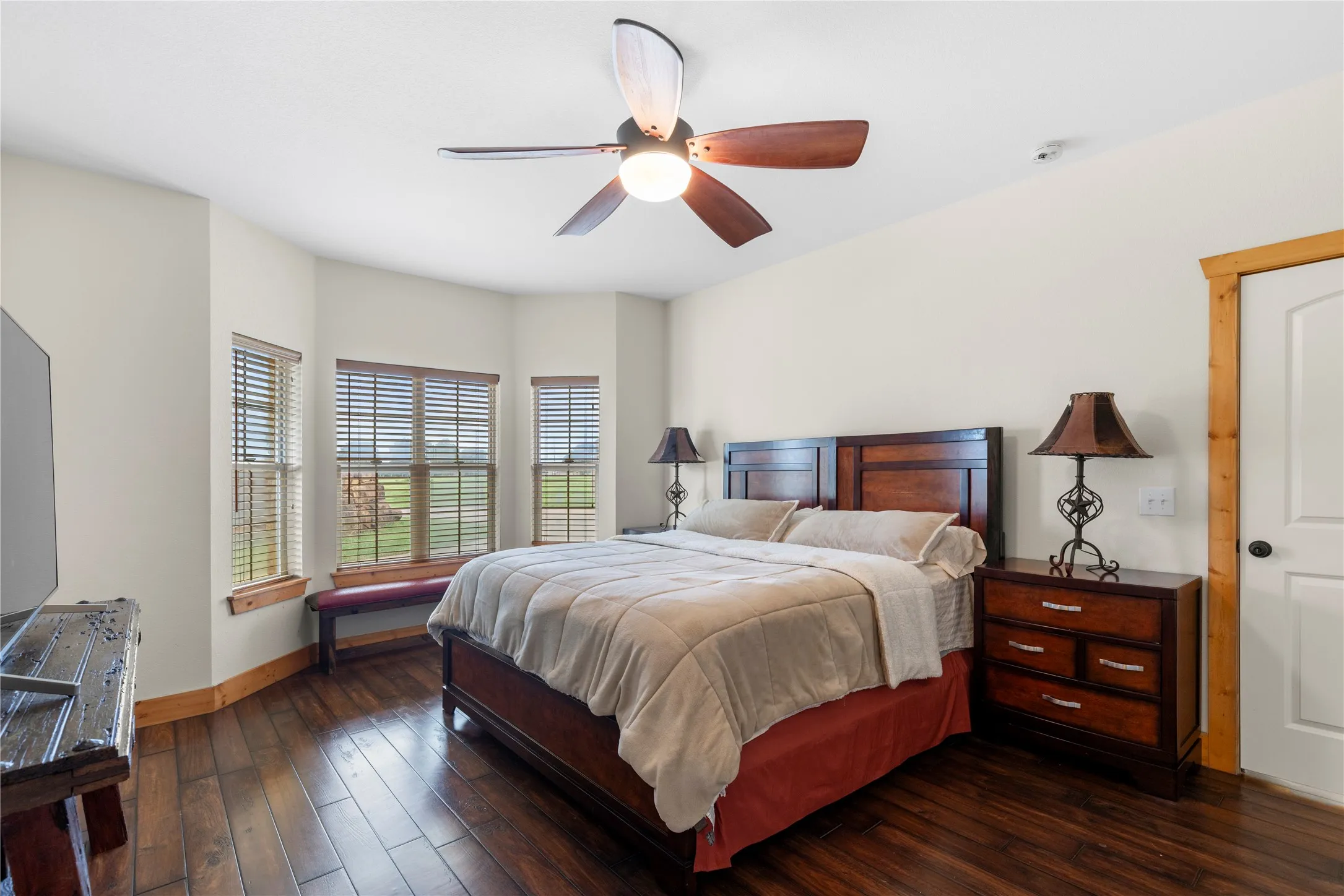 Bedroom featuring dark wood-style floors and ceiling fan