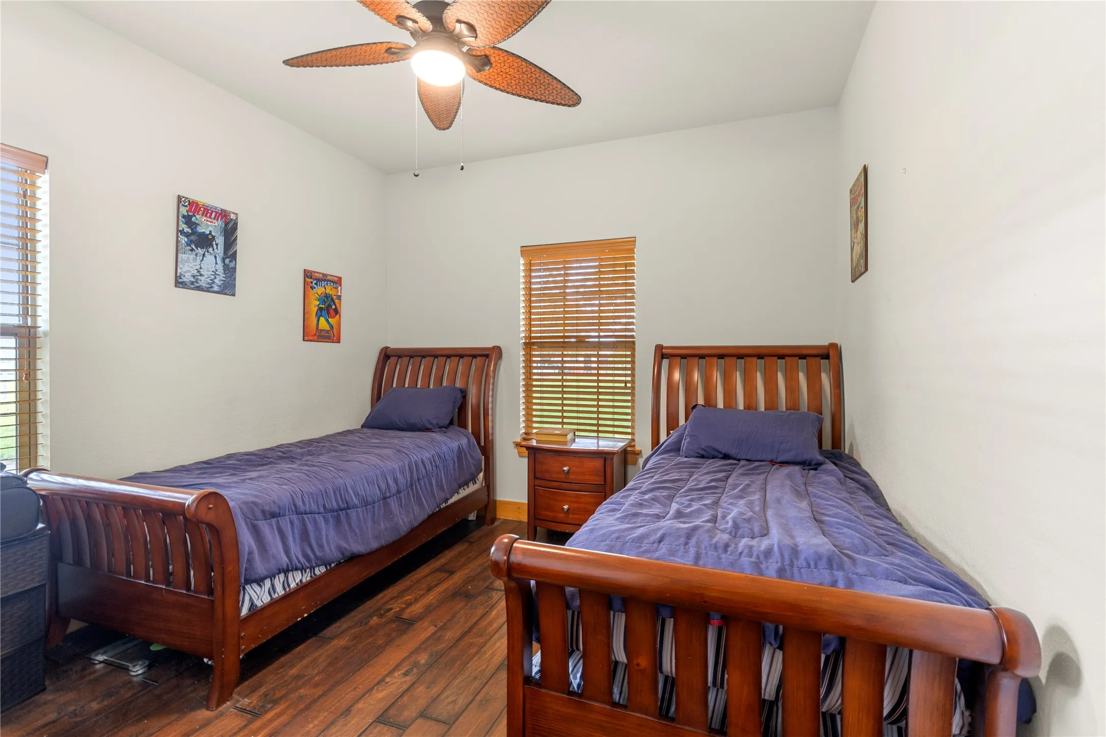 Bedroom featuring dark wood-type flooring and ceiling fan