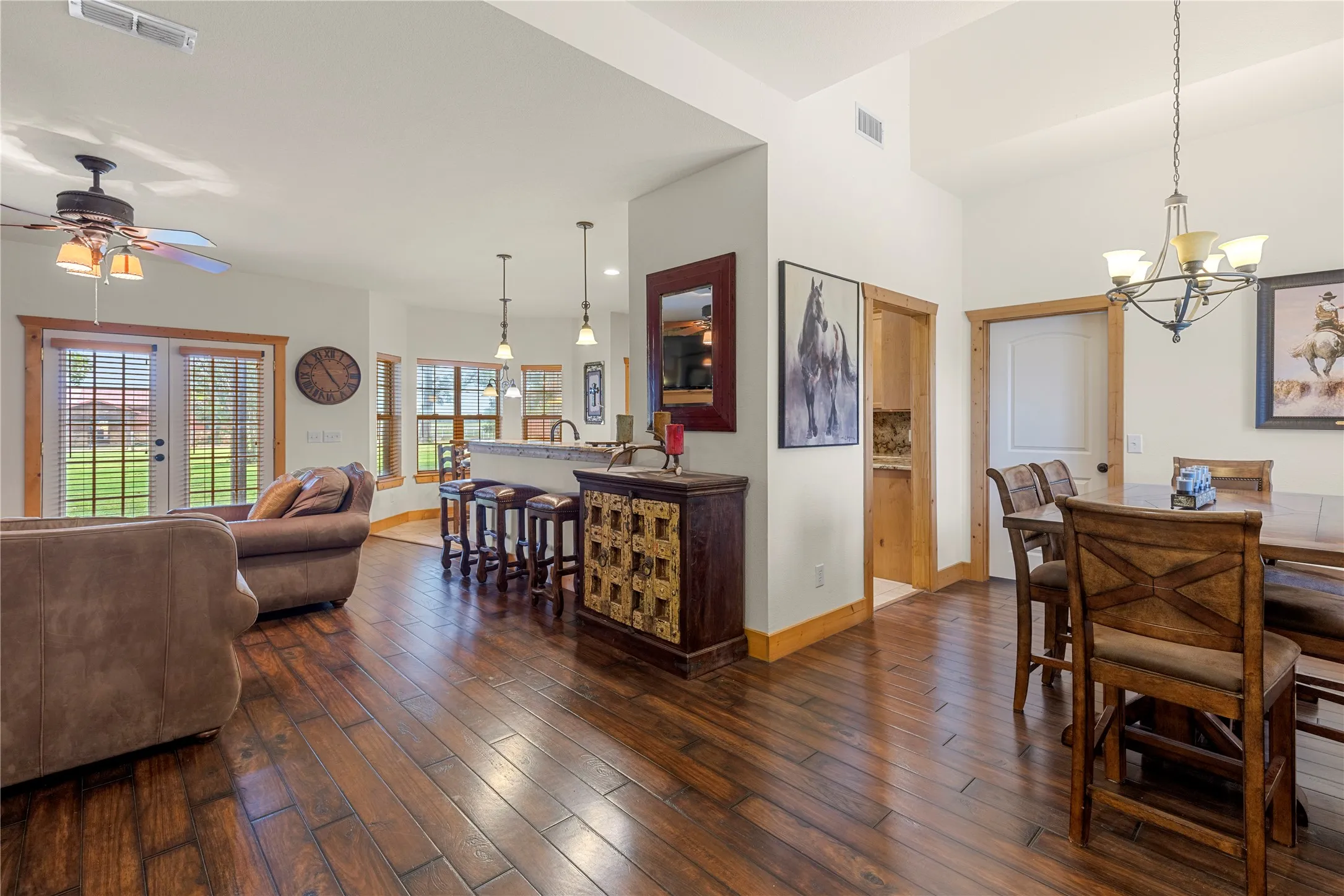 Dining room featuring dark wood-style floors, a chandelier, and ceiling fan
