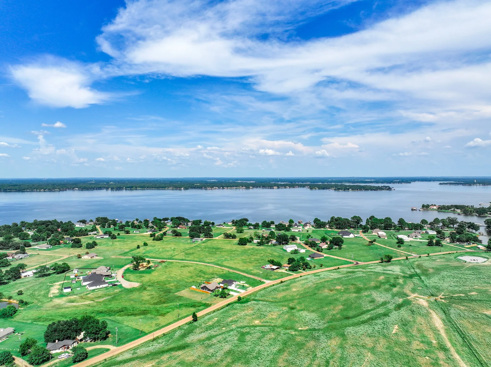 Aerial view of property and surrounding area featuring a large body of water