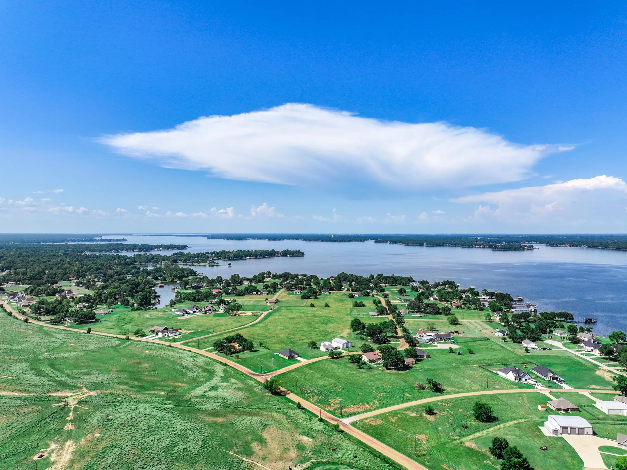 Aerial overview of property's location with a large body of water