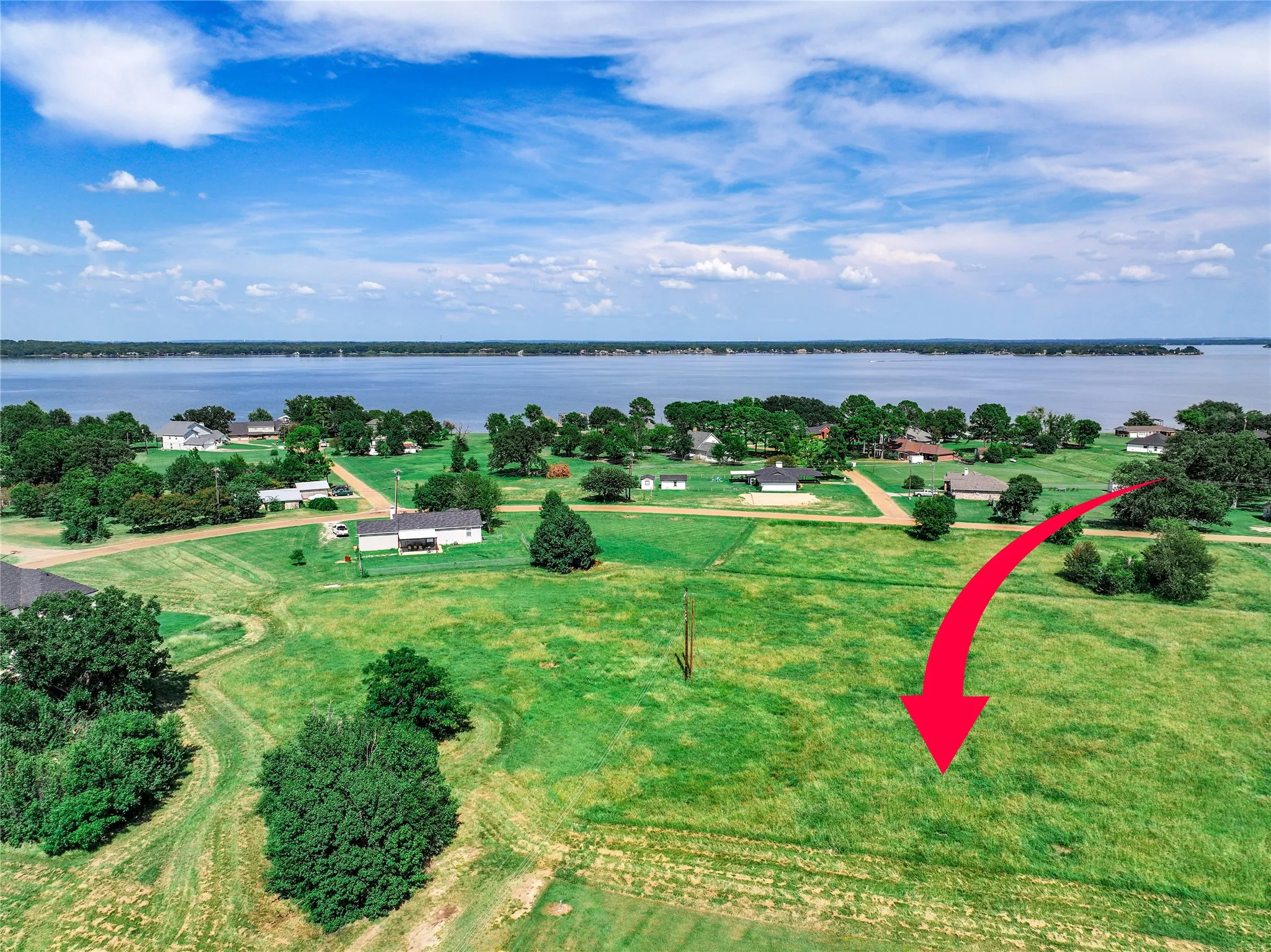 Aerial overview of property's location featuring a large body of water