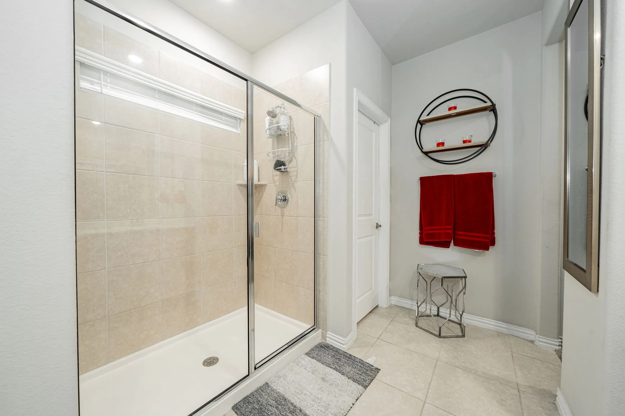 Full bath with a shower stall and tile patterned flooring