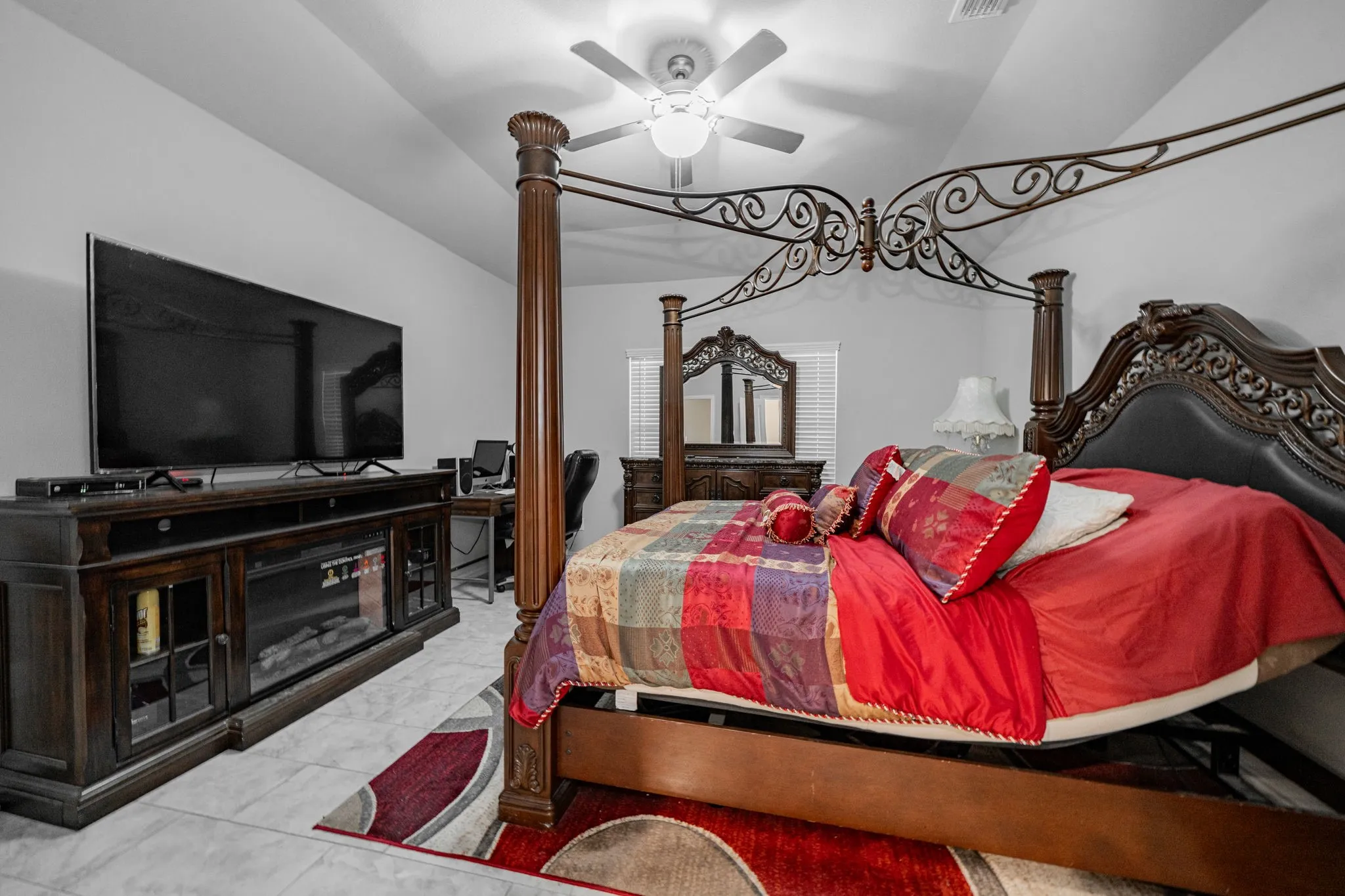 Bedroom with ceiling fan and vaulted ceiling