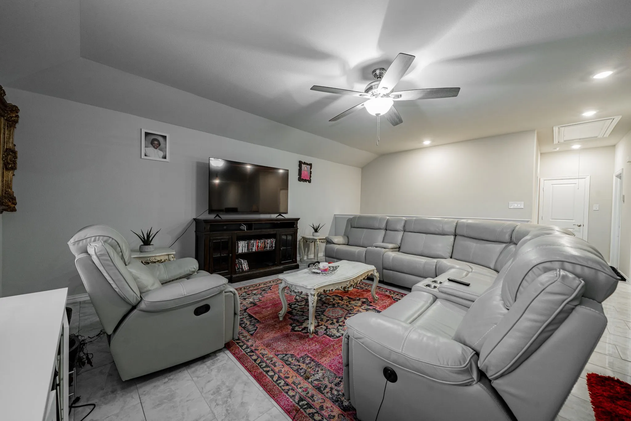 Living room featuring attic access, a ceiling fan, recessed lighting, and lofted ceiling