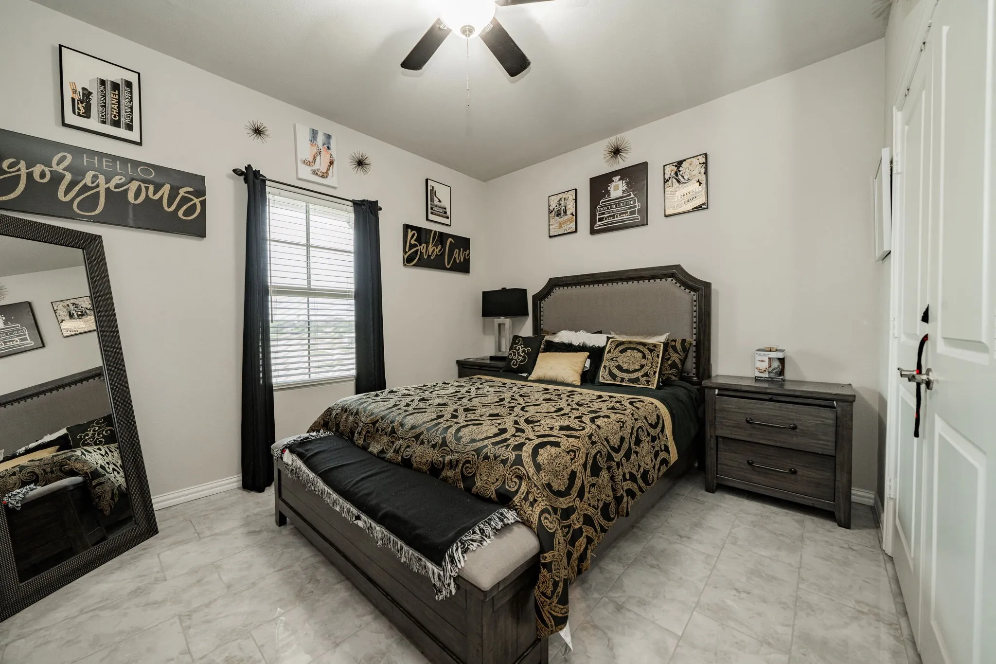 Bedroom featuring a ceiling fan and baseboards