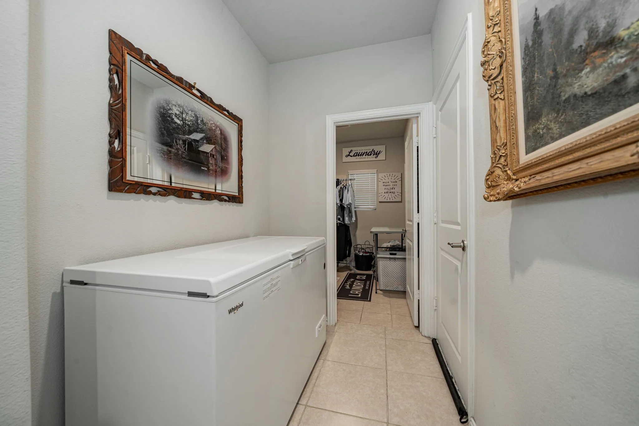 Corridor featuring light tile patterned floors