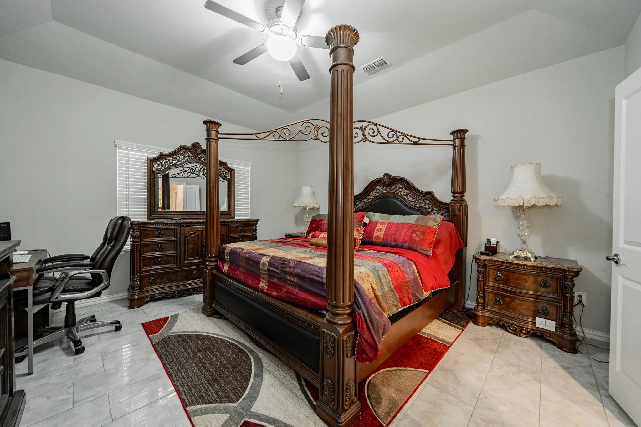 Bedroom featuring a desk, a ceiling fan, and vaulted ceiling