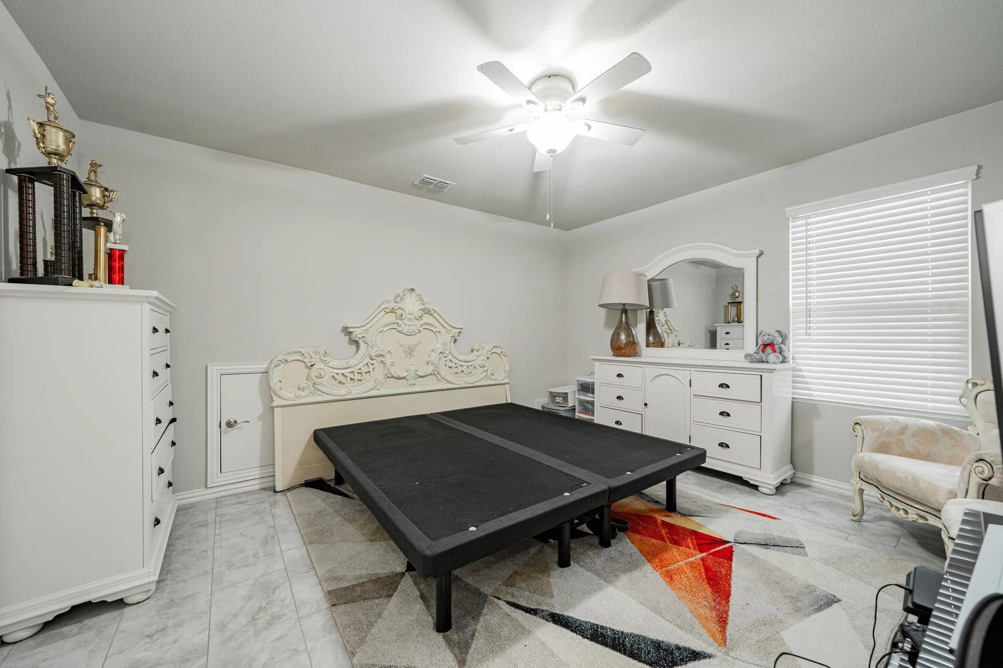 Bedroom featuring ceiling fan and baseboards