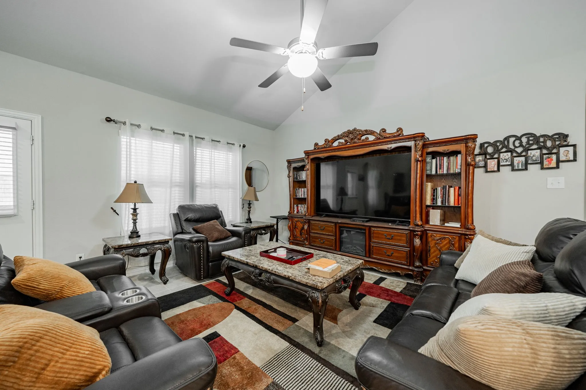 Living room with vaulted ceiling and ceiling fan