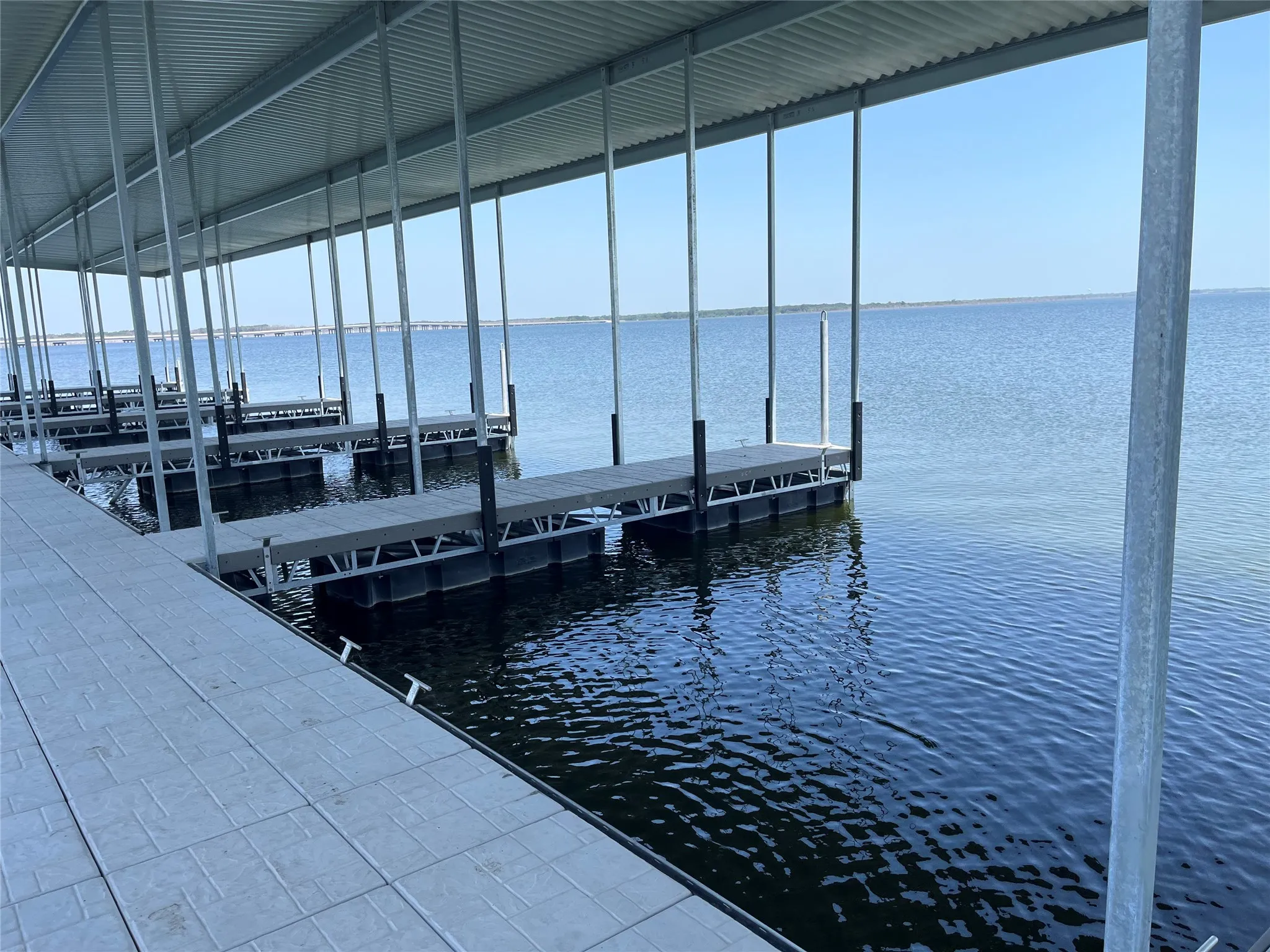 Covered boat slips featuring composite decking and a durable metal roof structure