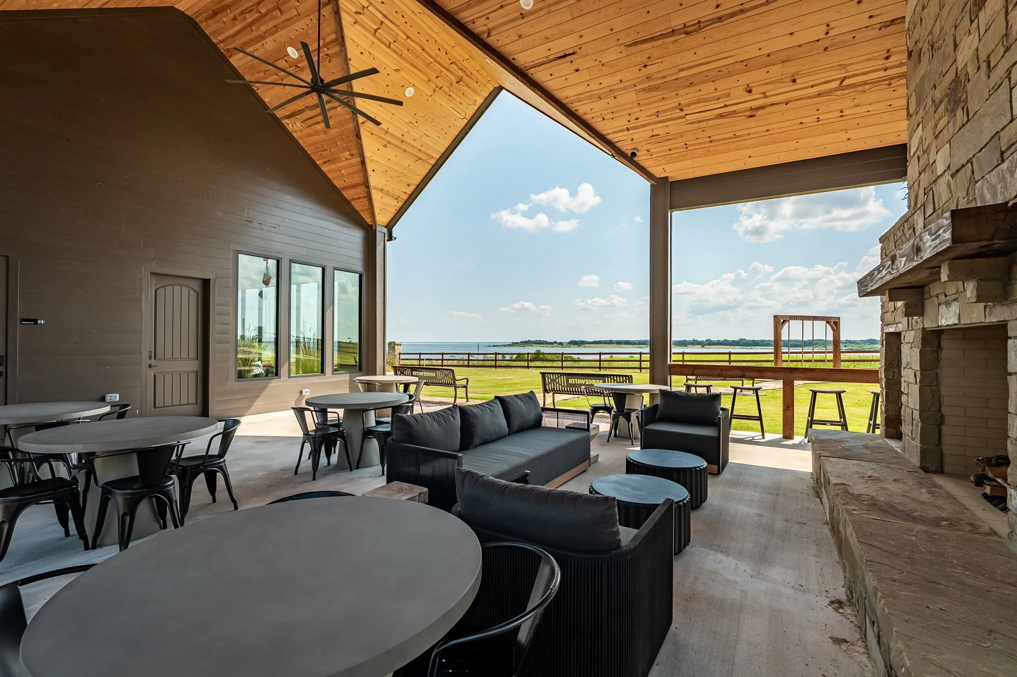 View of patio featuring outdoor dining area, an outdoor hangout area, and ceiling fan at Community Center
