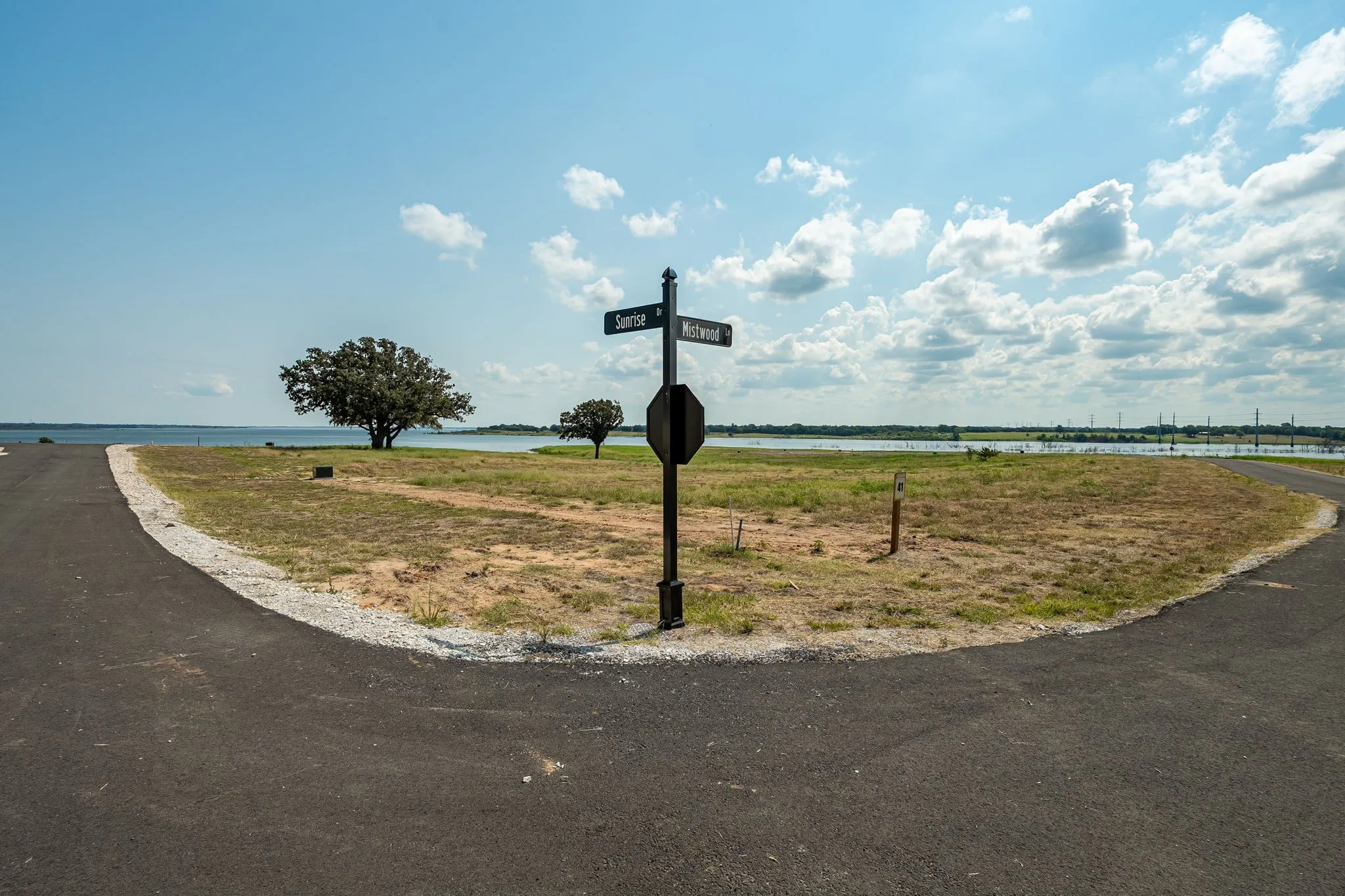 LOT 41 View of asphalt street featuring a water view and traffic signs