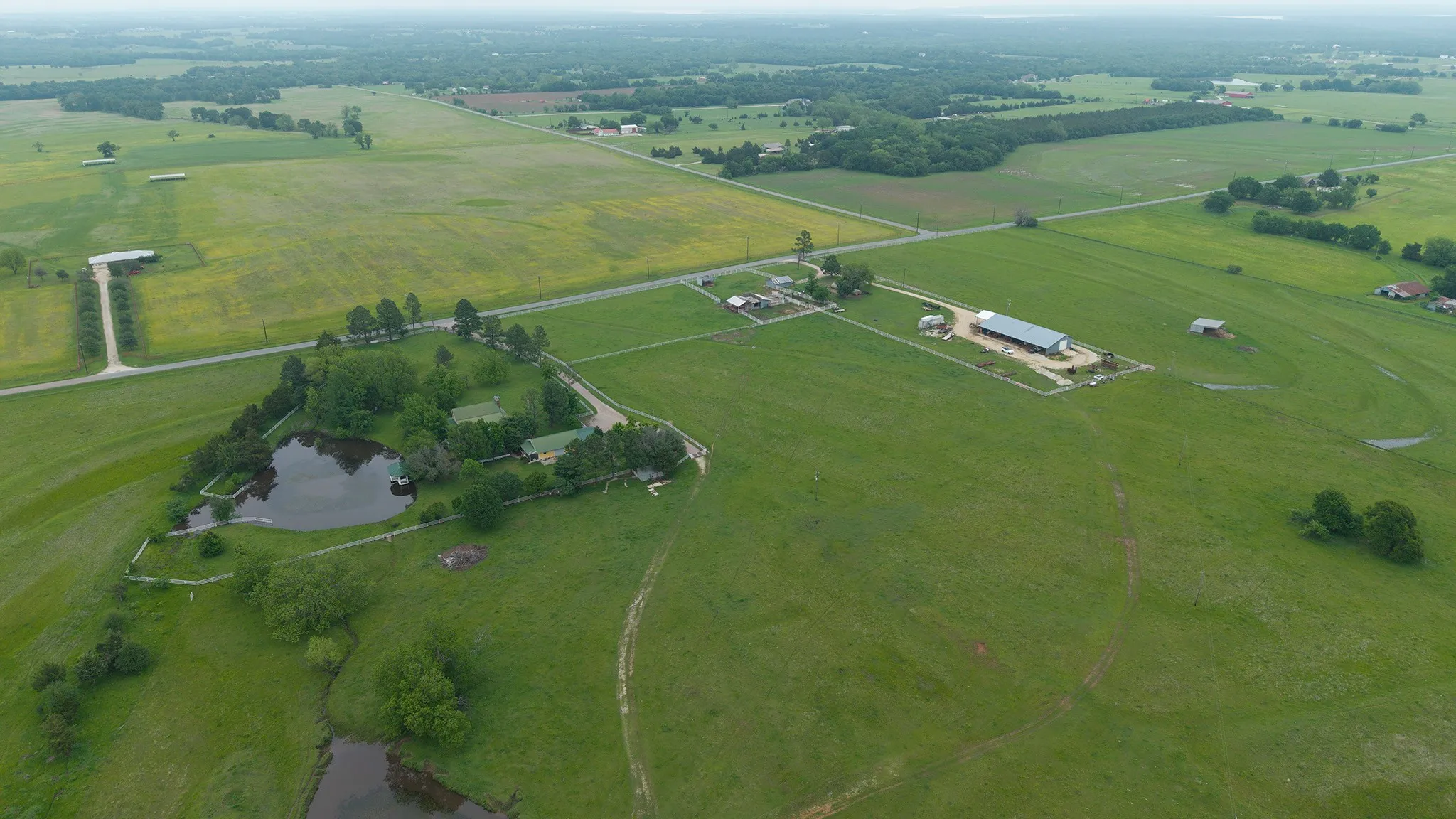 Aerial view of property and surrounding area featuring rural landscape