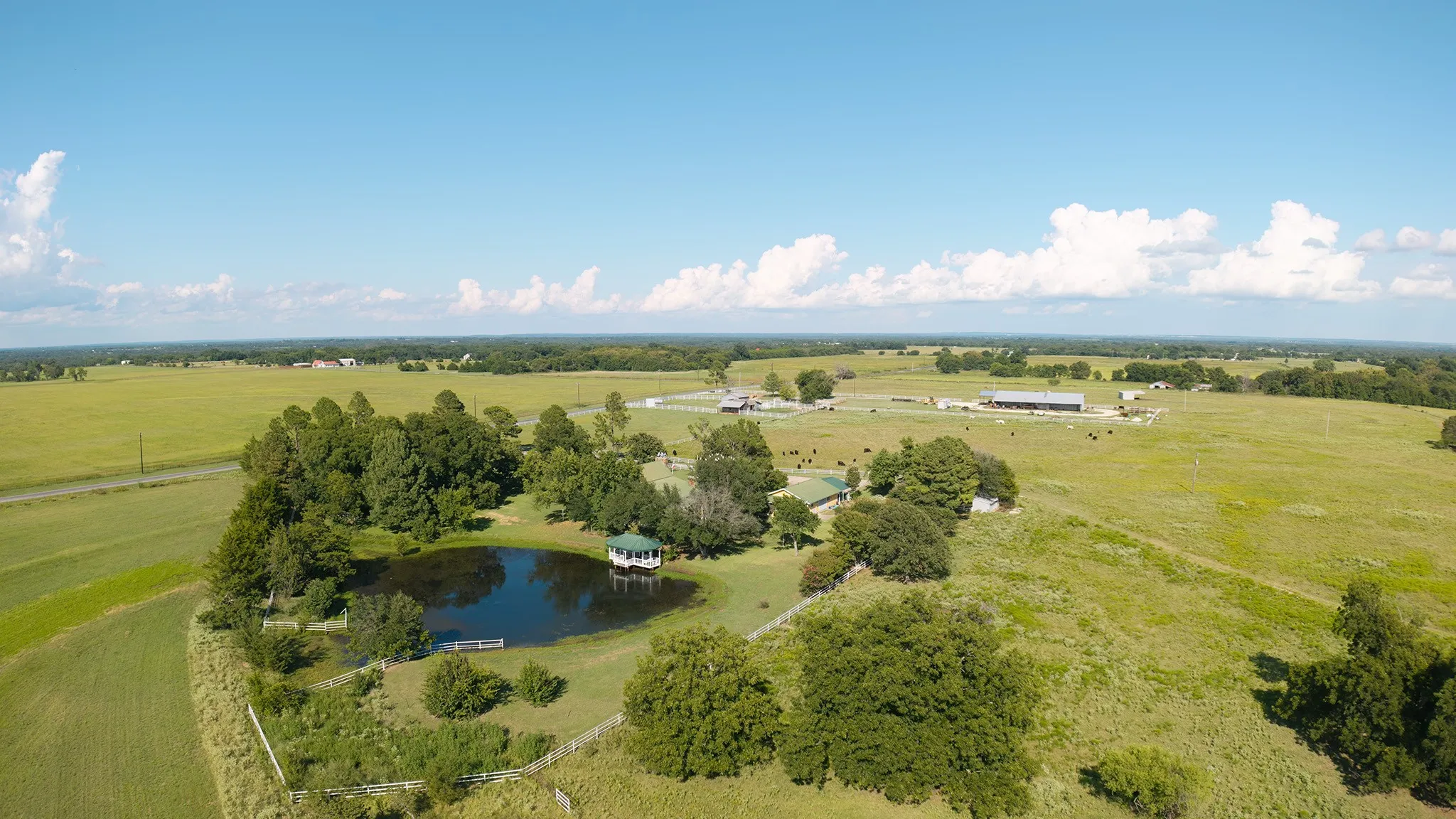Overview of rural landscape with a pastoral area and a nearby body of water