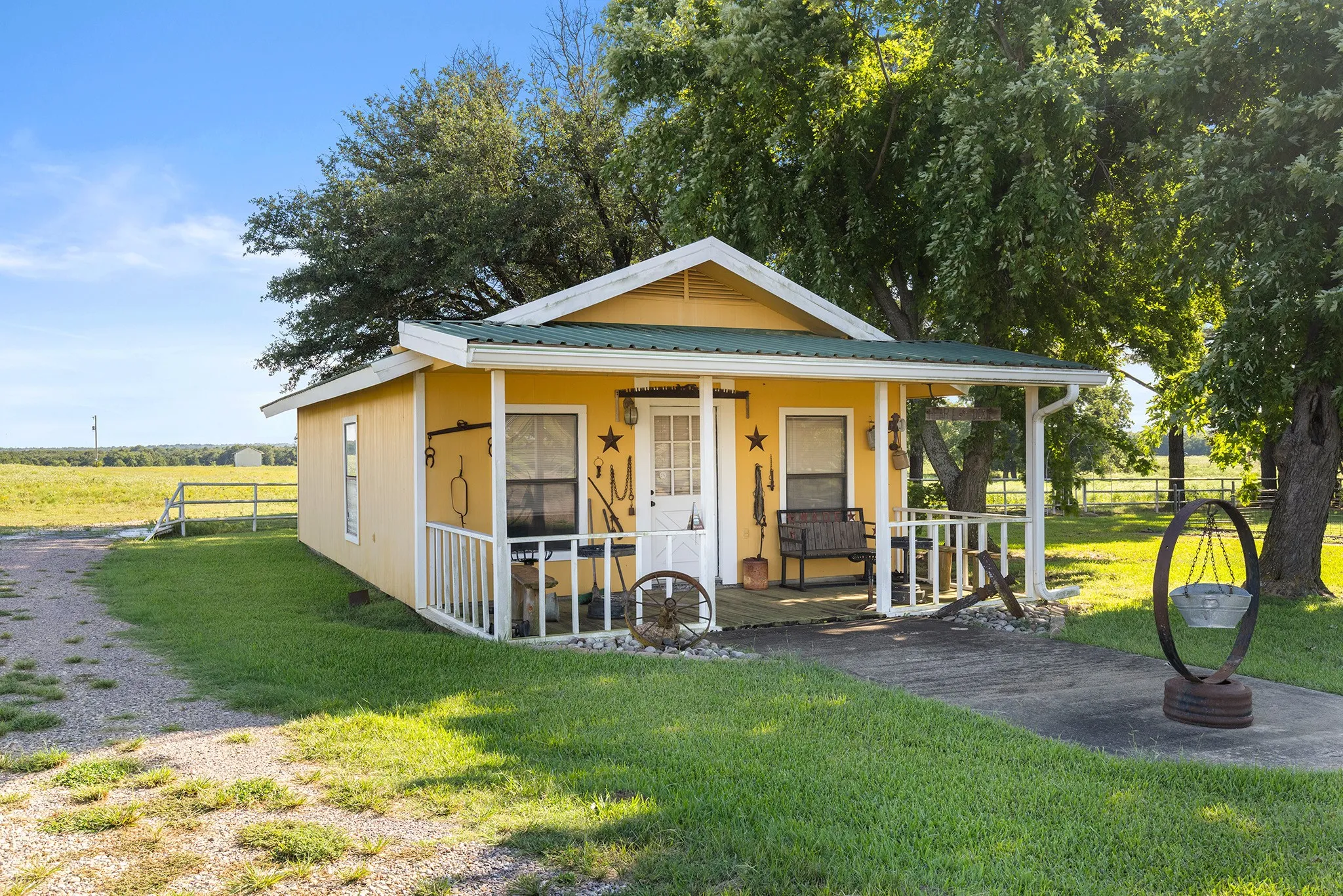 View of front of property with a porch, a rural view, and a metal roof