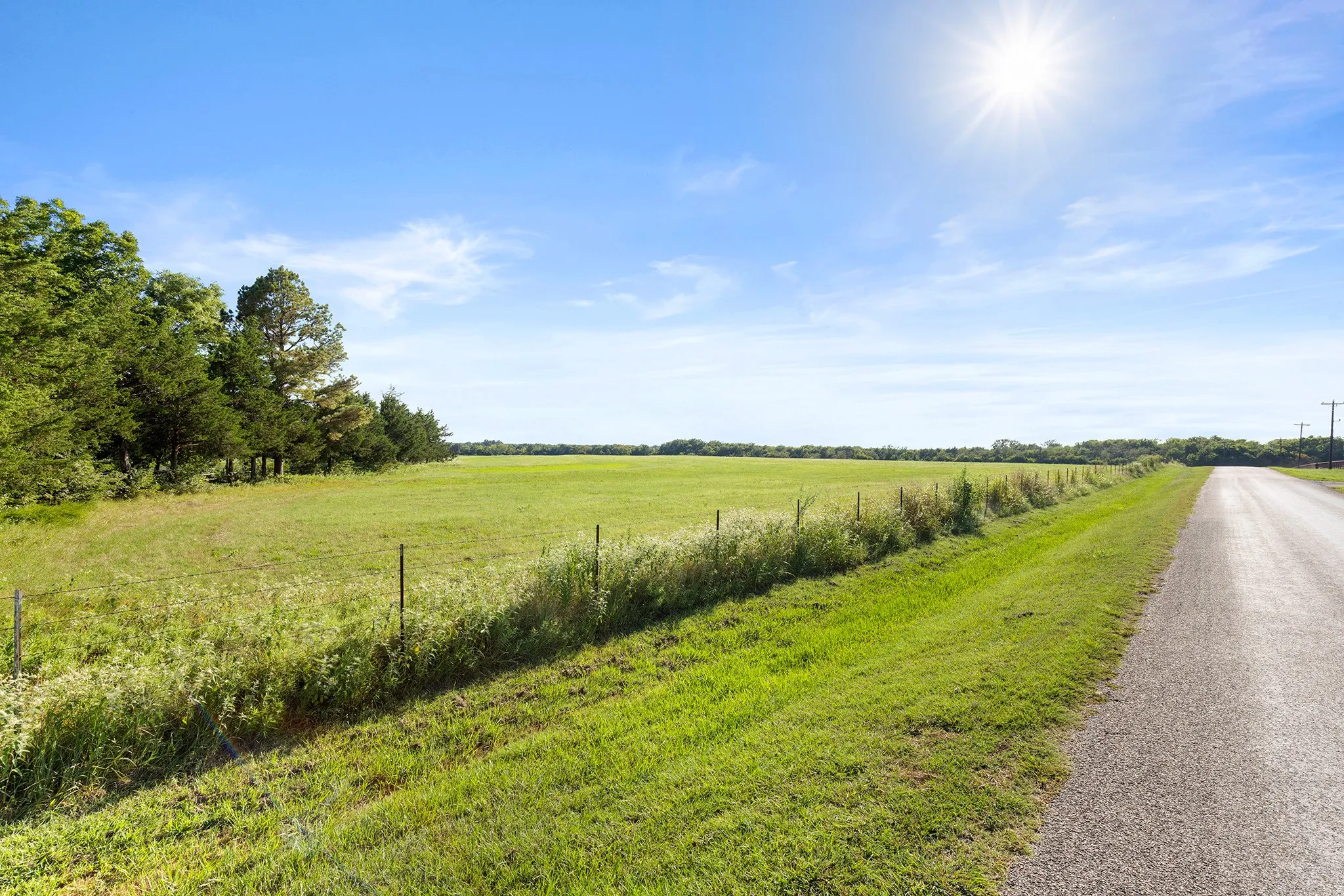 View of asphalt street with a view of rural / pastoral area