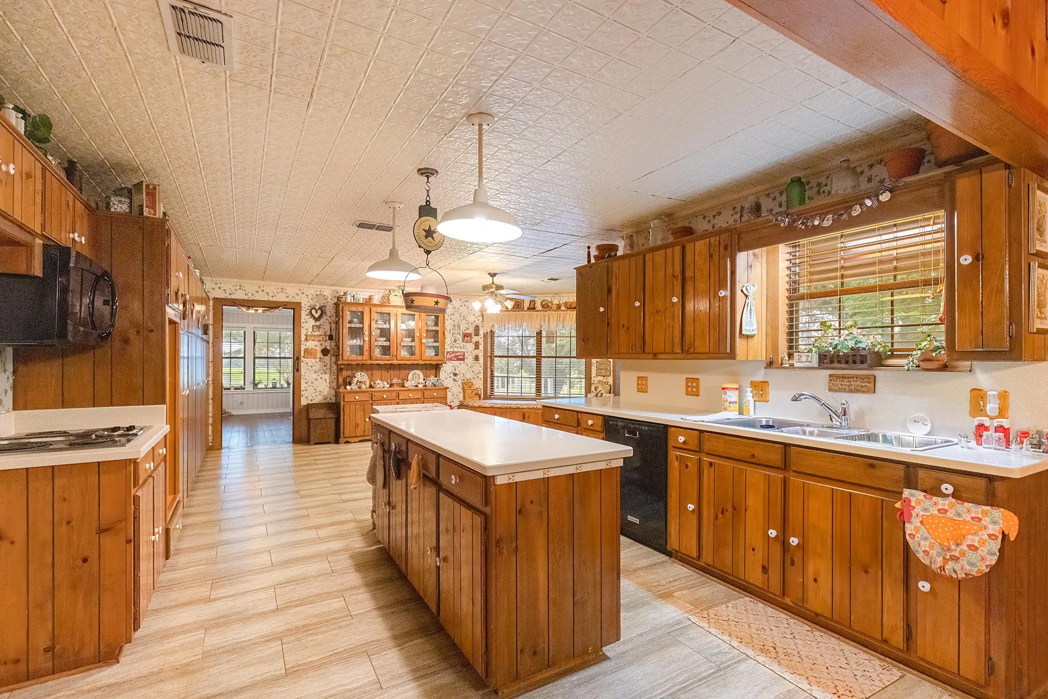 Kitchen featuring brown cabinets, a center island, and healthy amount of natural light