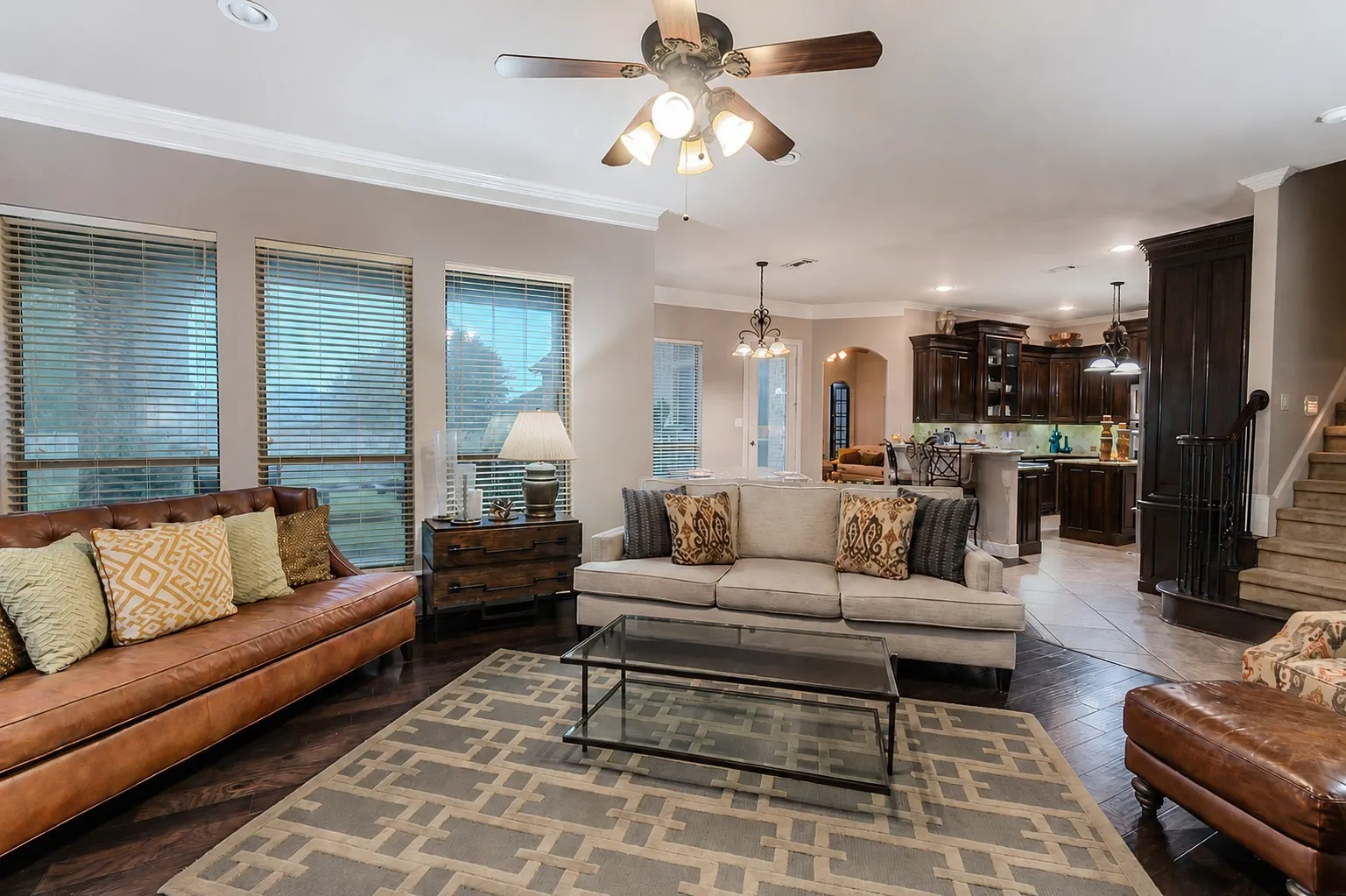Den with wood flooring and natural light - facing the kitchen area.