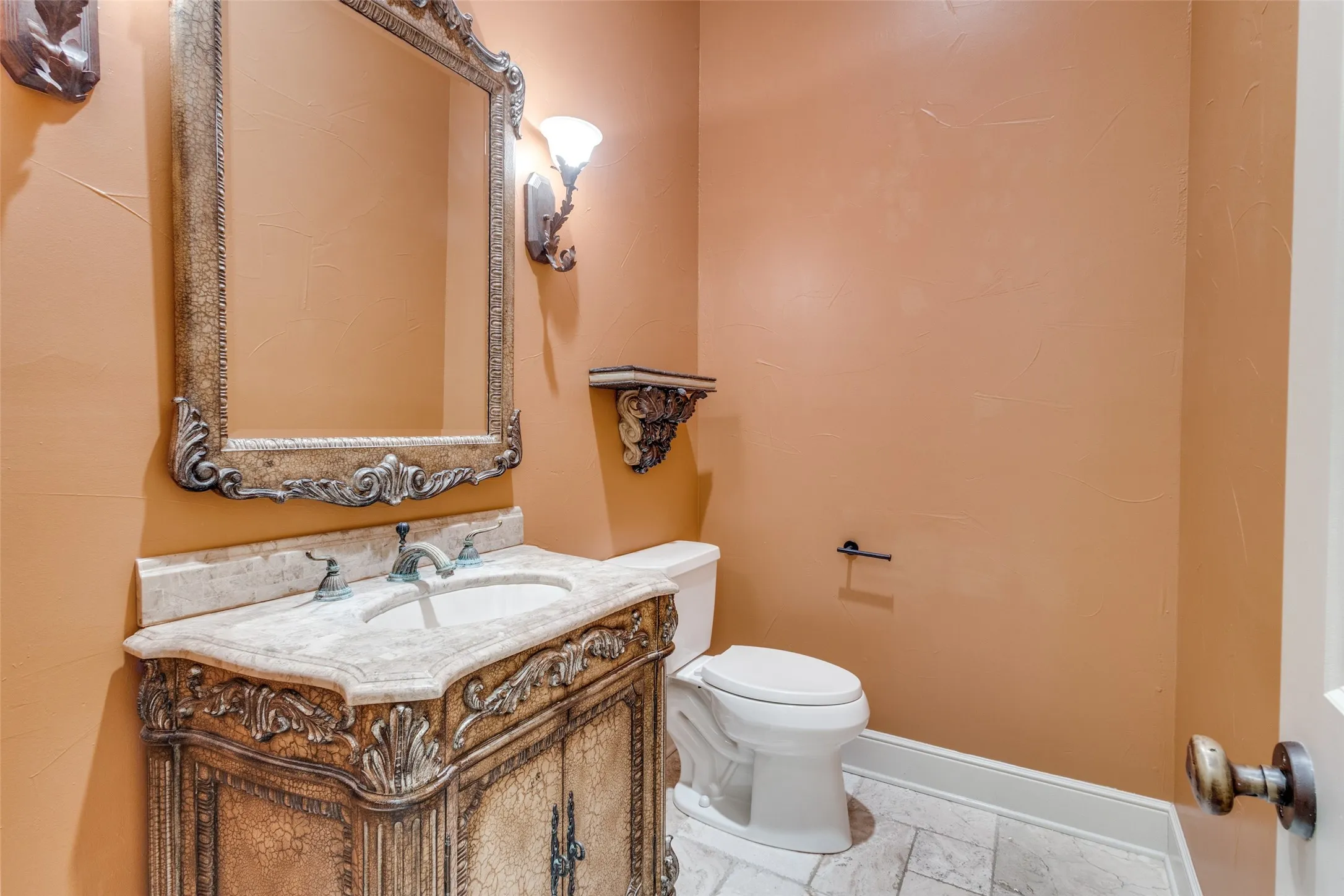 Half bathroom featuring vanity and toilet