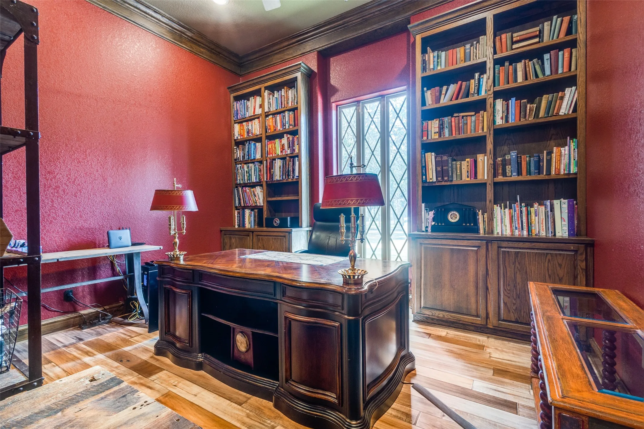 Office featuring a textured wall, ornamental molding, and light wood finished floors