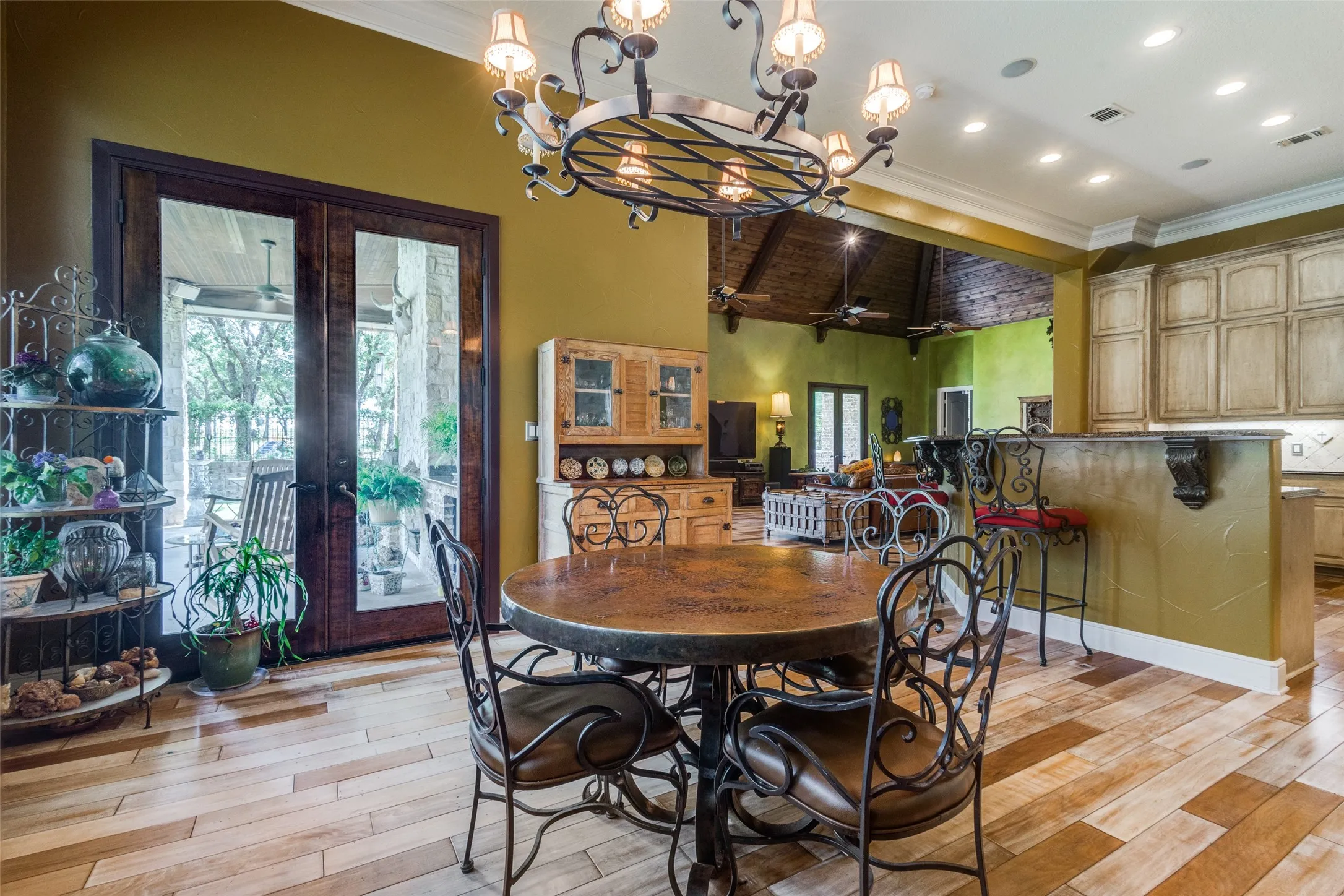 Dining space with light wood-type flooring, crown molding, french doors, a chandelier, and recessed lighting