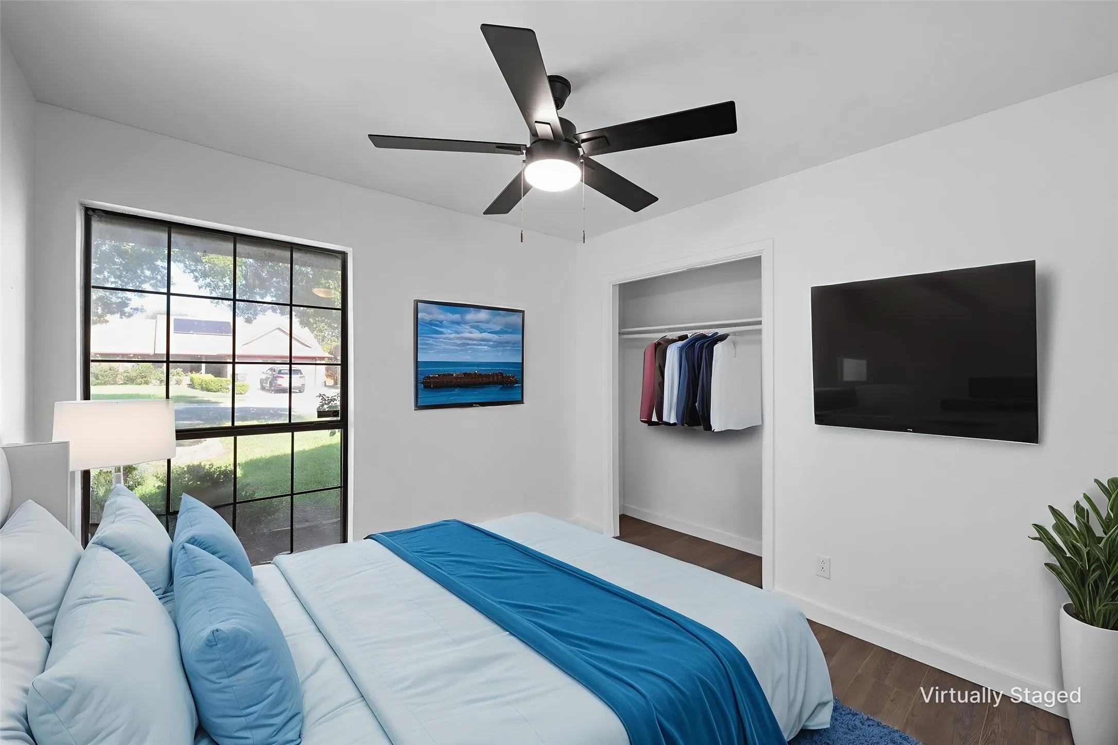 Bedroom featuring dark wood-style floors, a closet, and a ceiling fan