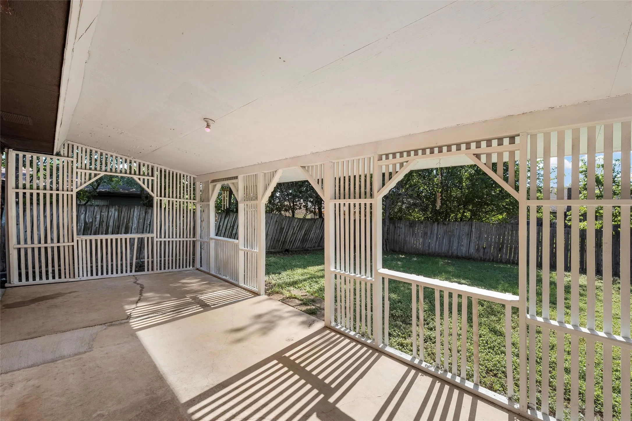 Fenced backyard with a patio
