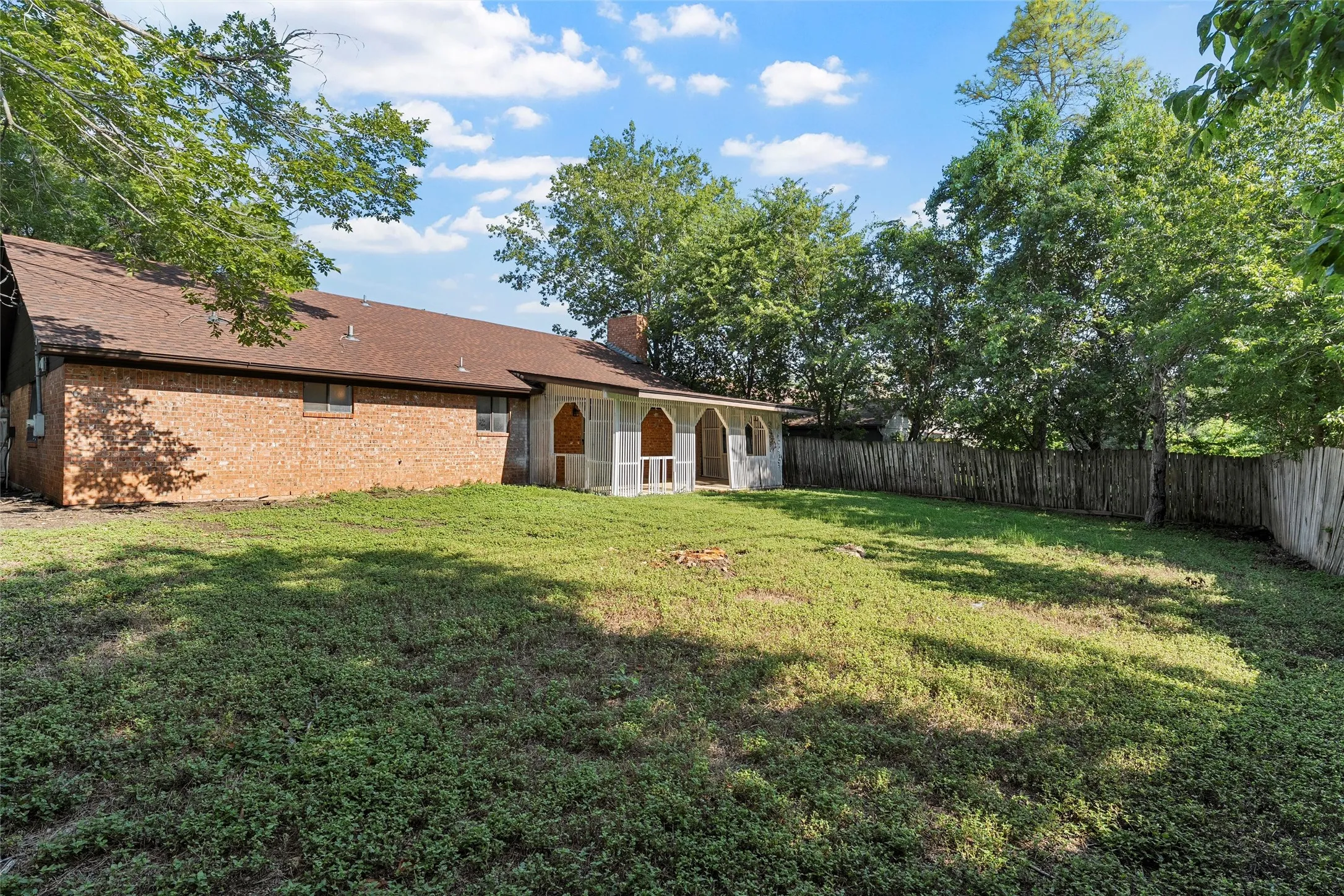 Fenced backyard with a patio area