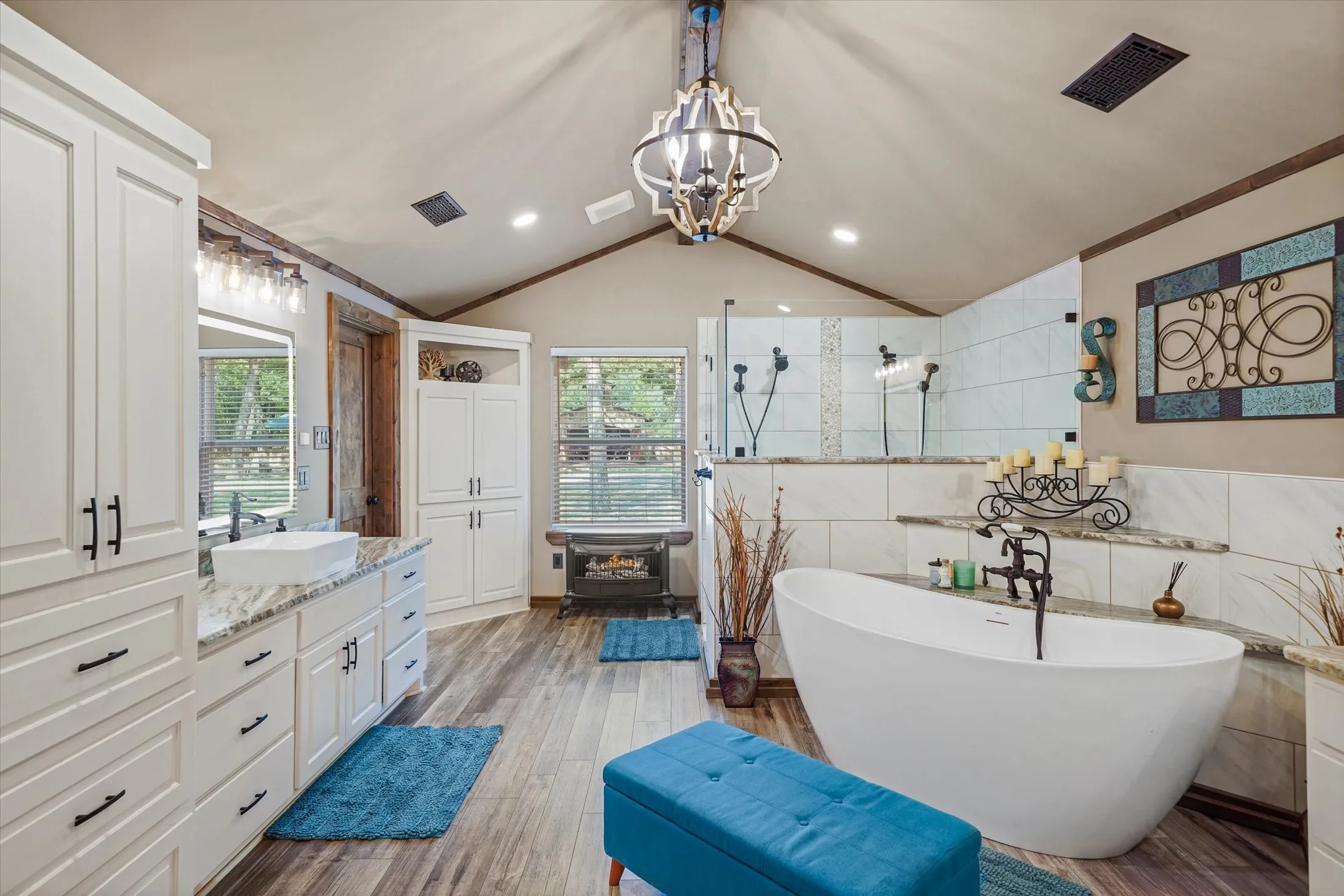 Full bathroom with a walk in shower, vanity, tile walls, a freestanding tub, and light wood-style flooring