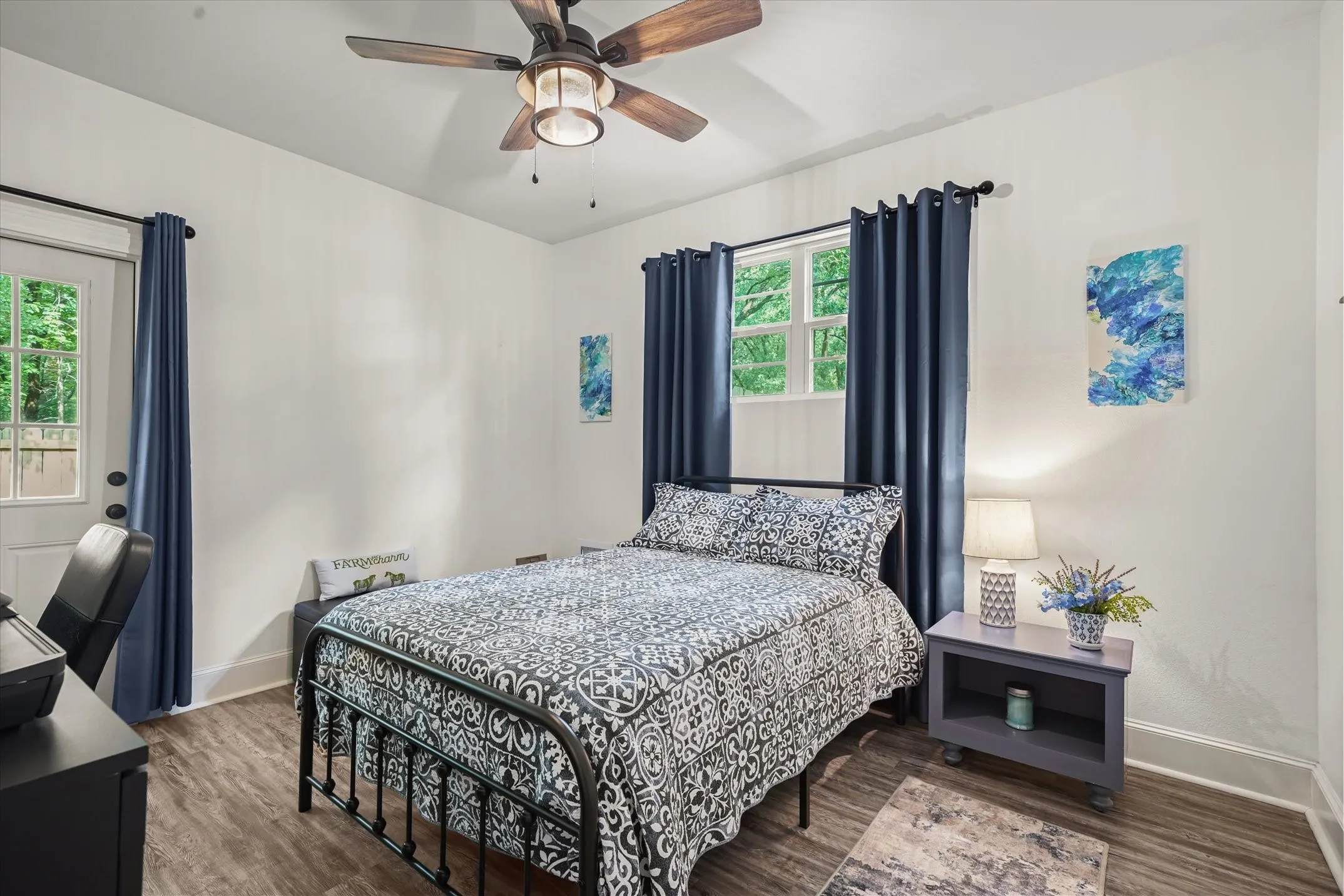 Bedroom with wood finished floors and a ceiling fan