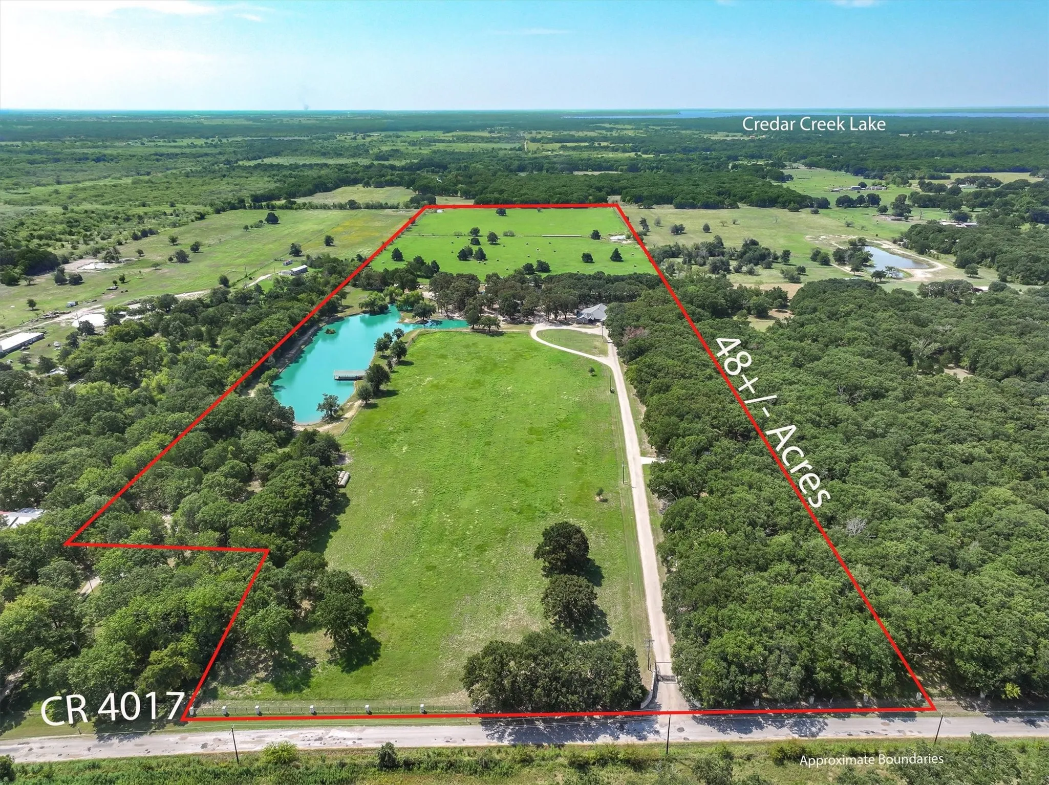 Overview of rural landscape with property parcel outlined and a large body of water