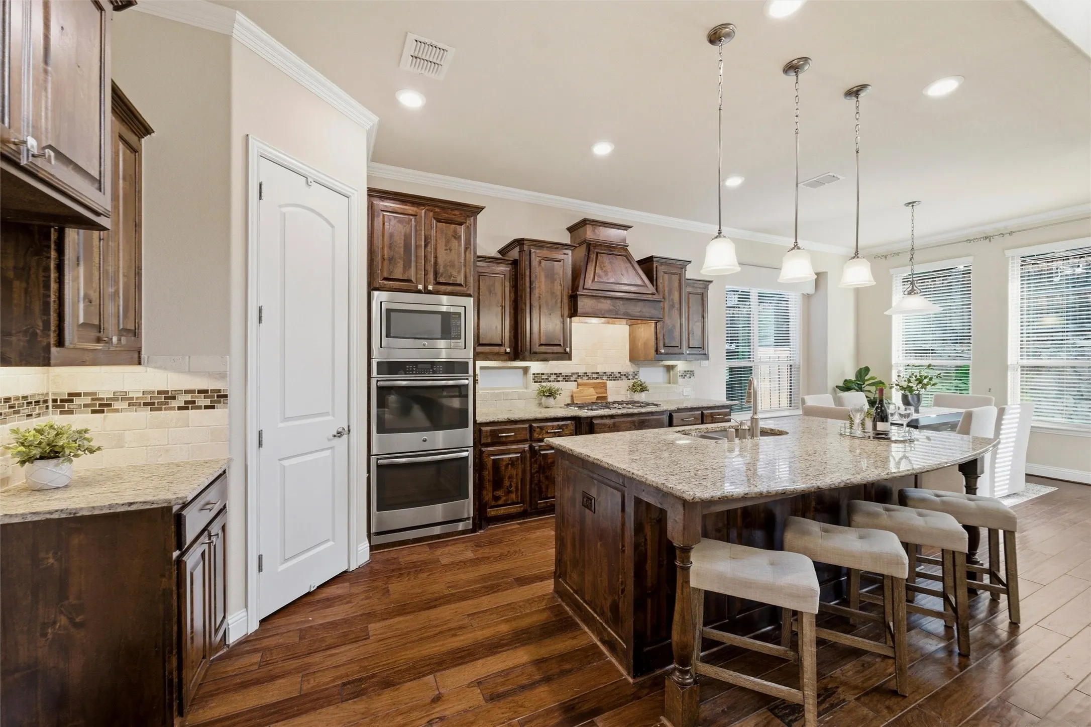 Knotty dark cabinets and granite countertops, perfectly designed to embrace your culinary spirit.