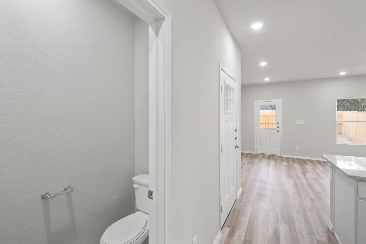 Half bathroom featuring plenty of natural light, light wood-type flooring, vanity, and recessed lighting