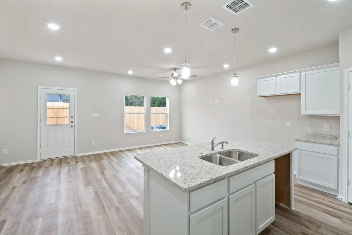 Kitchen with white cabinets, recessed lighting, ceiling fan, light wood-type flooring, and pendant lighting