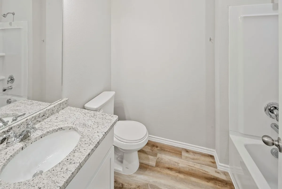 Full bath featuring light wood-style floors, shower / tub combination, and vanity