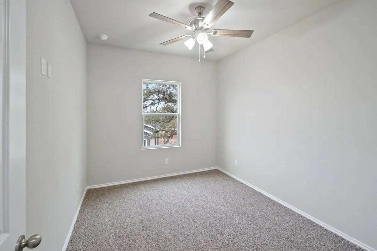 Unfurnished room with carpet floors and a ceiling fan